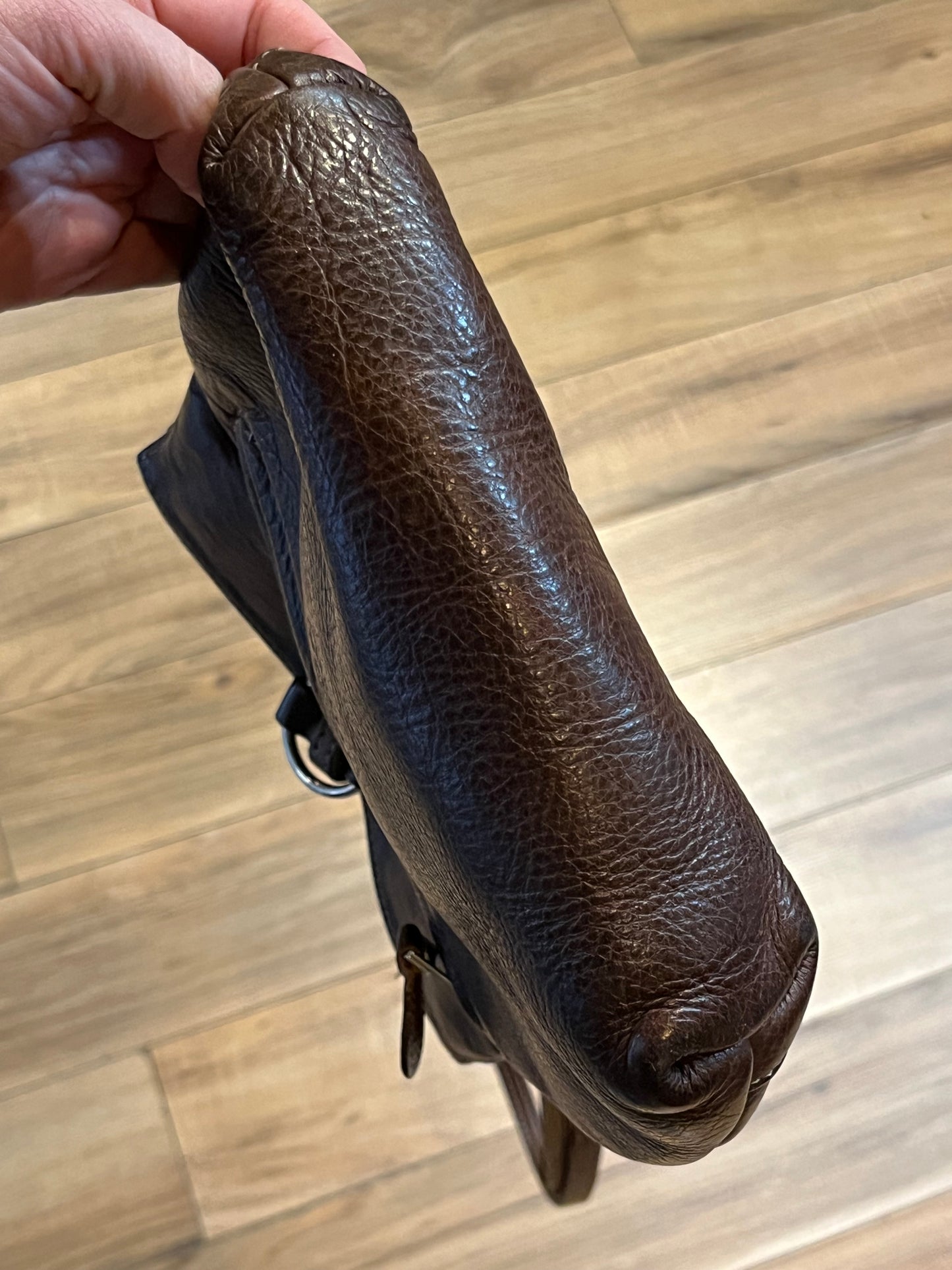 Vintage Roots brown leather crossbody/ knapsack, with two shoulder straps which can we worn as a knapsack or unclipped and worn as a cross body bag, one outer zip pocket and one main inner compartment.
