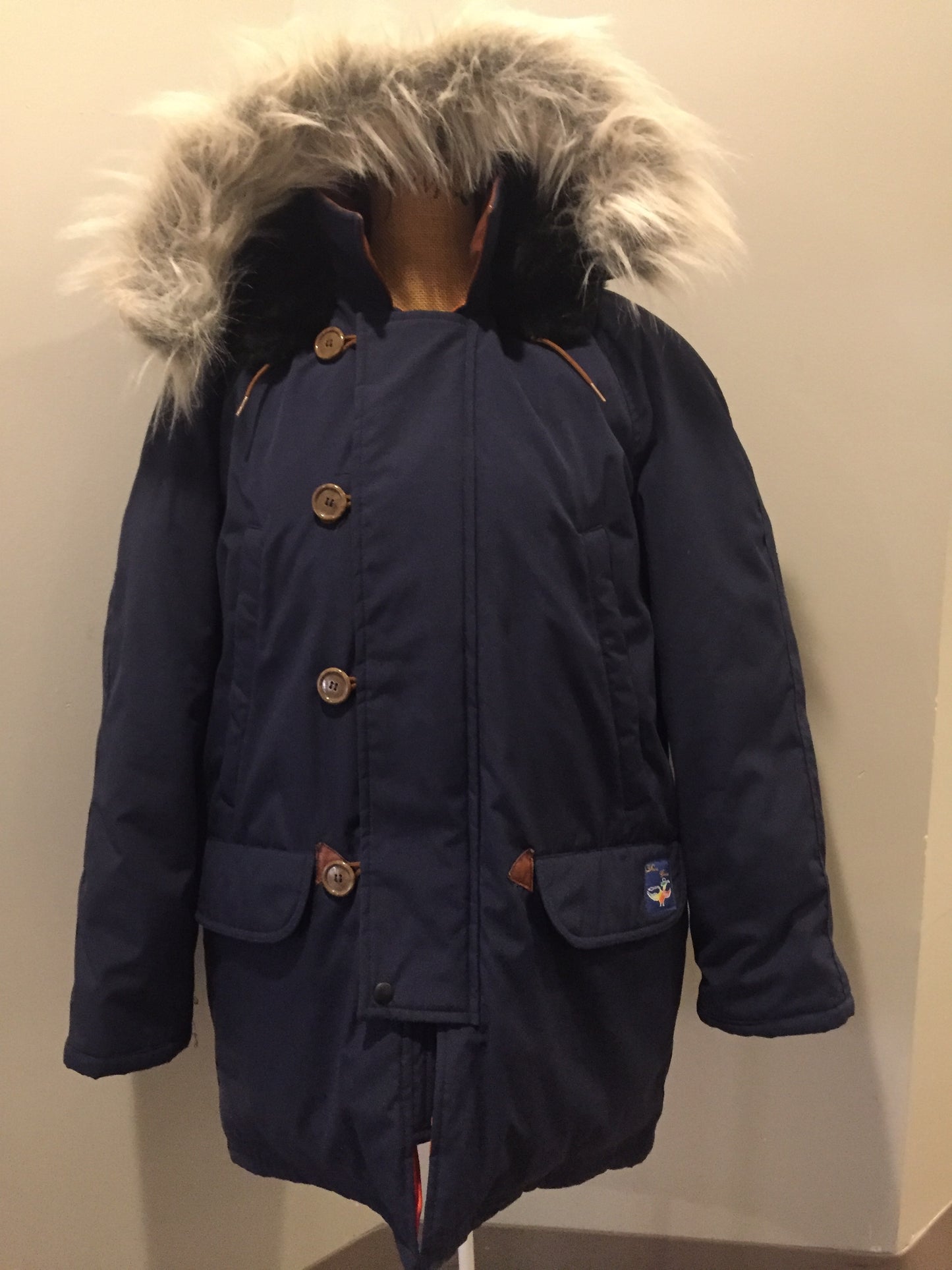 Kingspier Vintage - Rare Snow Goose parka from the 1970’s/1980’s (former name of Canada Goose) in navy with leather details and fur trimmed hood, slash pockets, flap pockets, zipper and button closures, “Snow Goose” patch on the front pocket, orange lining. Made in Canada. Size 40M.