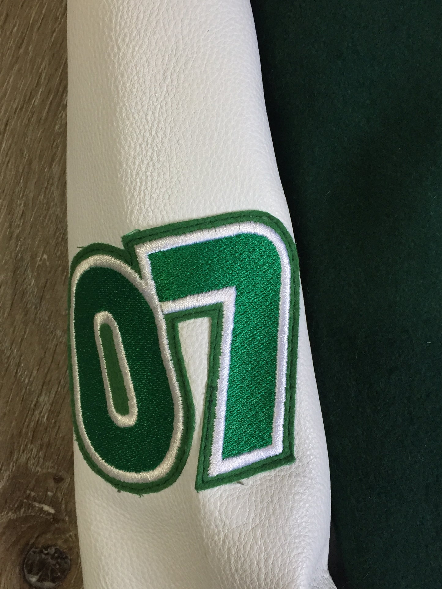 Kingspier Vintage - Roots “Sobey’s Centenary Anniversary” ’07 varsity jacket in green and white with snap closures, slash pockets, knit trim, embroidered “100” emblem on the chest and “07” on the arm.