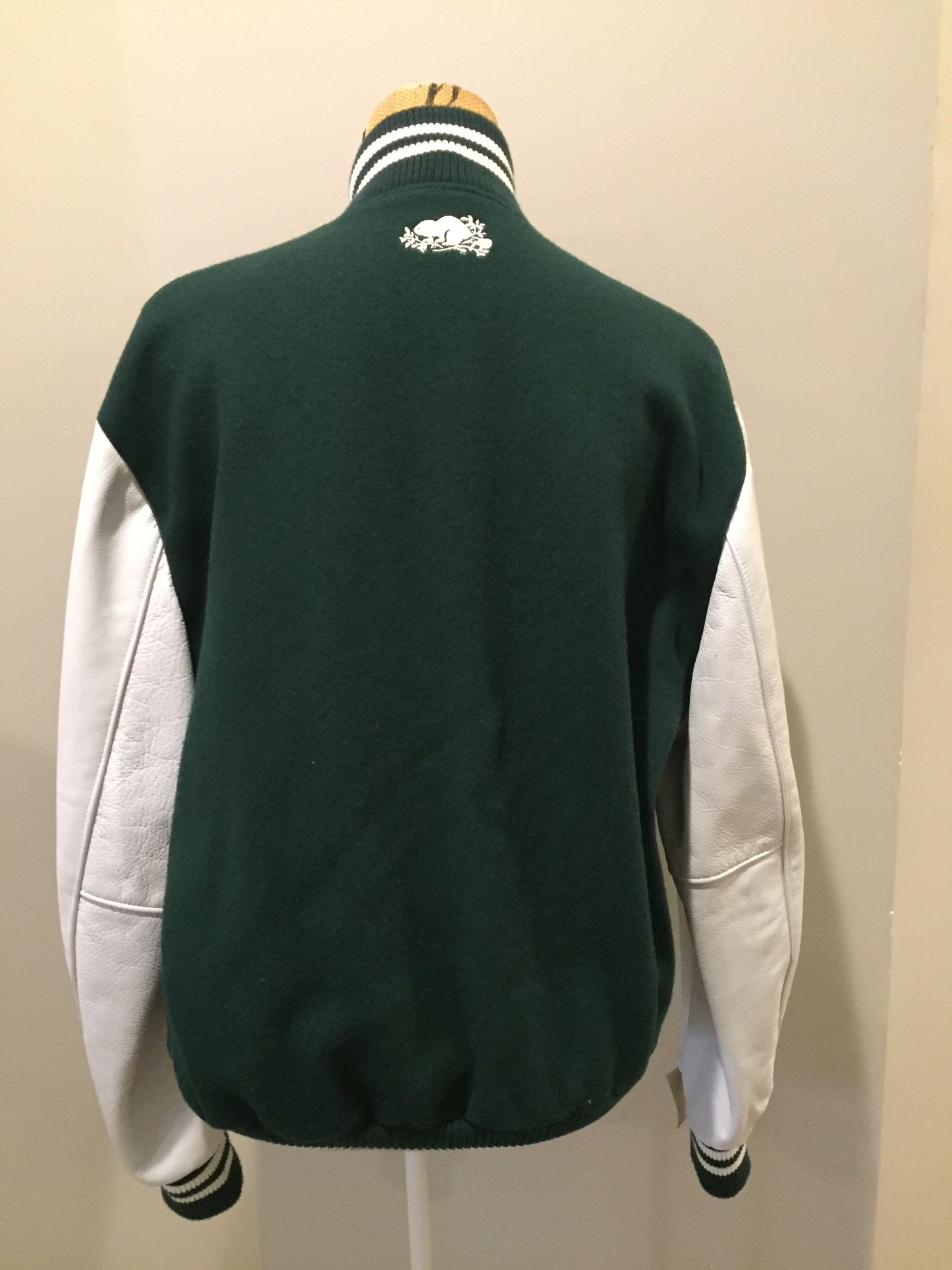 Kingspier Vintage - Roots “Sobey’s Centenary Anniversary” ’07 varsity jacket in green and white with snap closures, slash pockets, knit trim, embroidered “100” emblem on the chest and “07” on the arm.