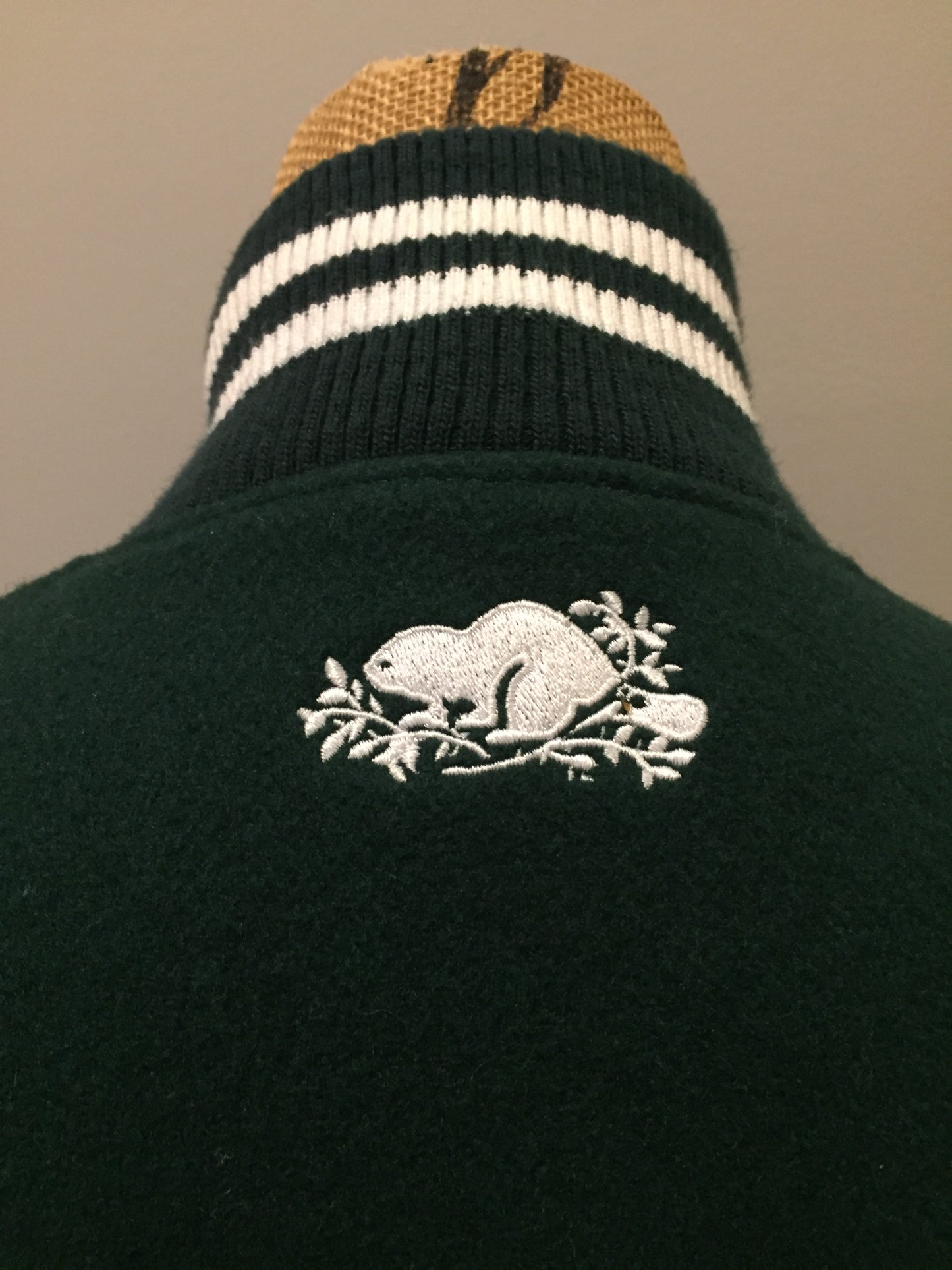 Kingspier Vintage - Roots “Sobey’s Centenary Anniversary” ’07 varsity jacket in green and white with snap closures, slash pockets, knit trim, embroidered “100” emblem on the chest and “07” on the arm.