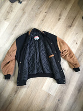 Load image into Gallery viewer, Kingspier Vintage - Trimark black and brown wool/leather varsity jacket with knit trim, snap closures, slash pockets quilted lining and inside pocket. Size large.
