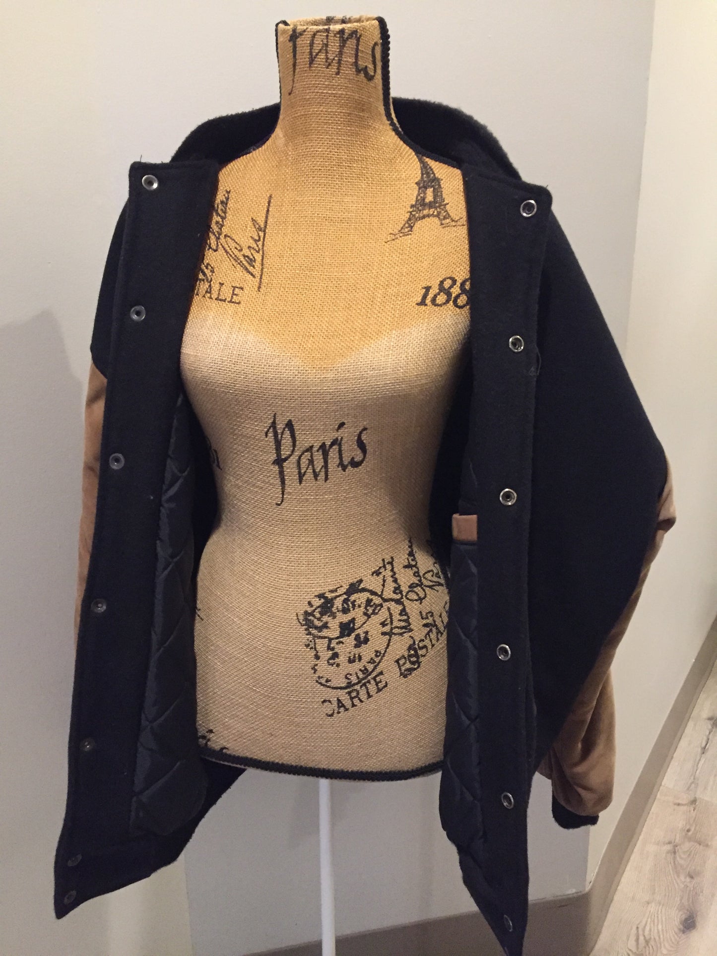 Kingspier Vintage - Trimark black and brown wool/leather varsity jacket with knit trim, snap closures, slash pockets quilted lining and inside pocket. Size large.