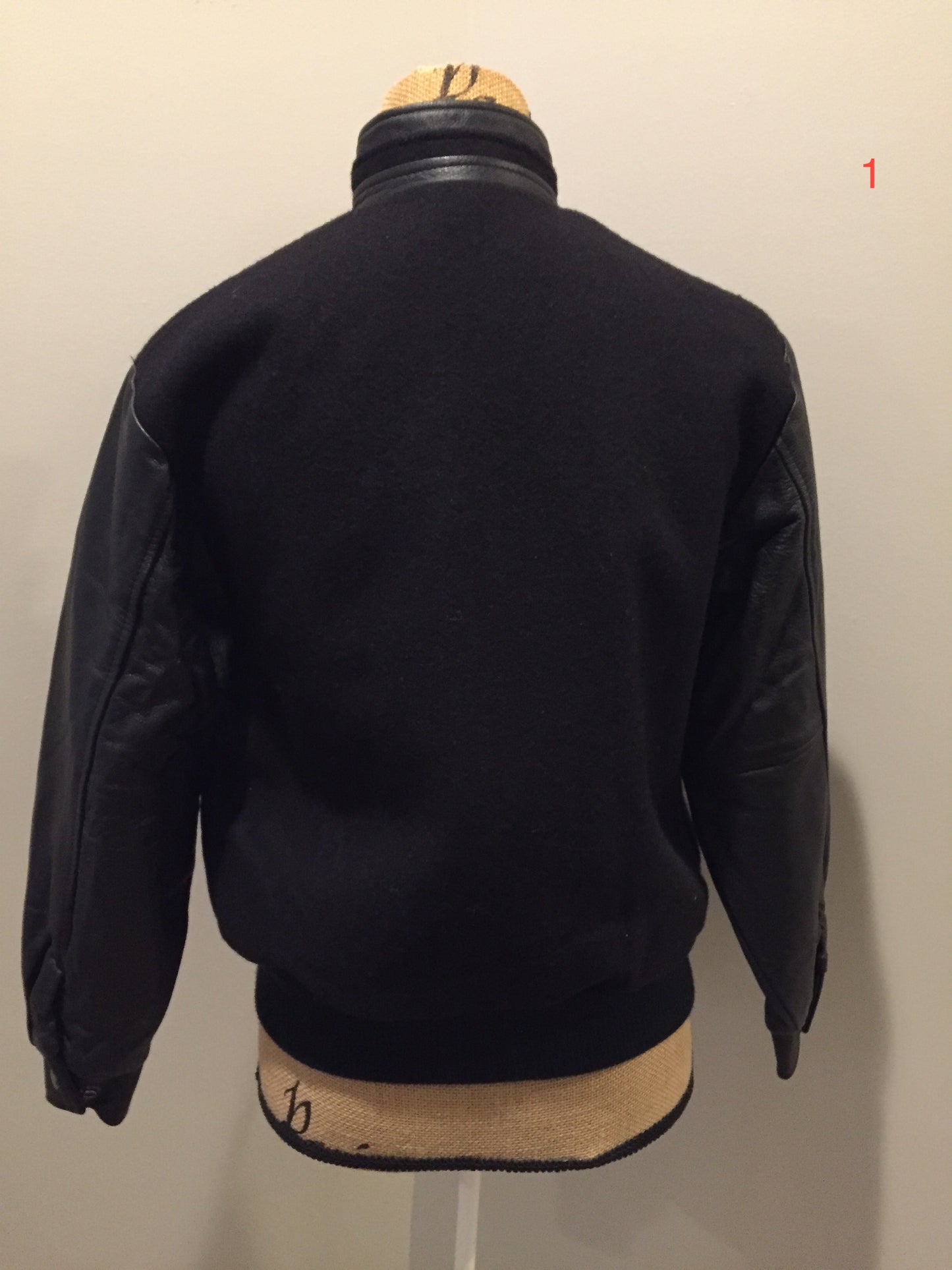 Kingspier Vintage - Concord black leather and wool varsity jacket with zipper and snap closures and slash pockets. Size XS.