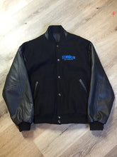Load image into Gallery viewer, Kingspier Vintage - Konica “film and Cameras” wool and leather varsity jacket in black with snap closures, slash pockets, inside pocket and “get ready” written across the back with a race car illustration. Size large.

