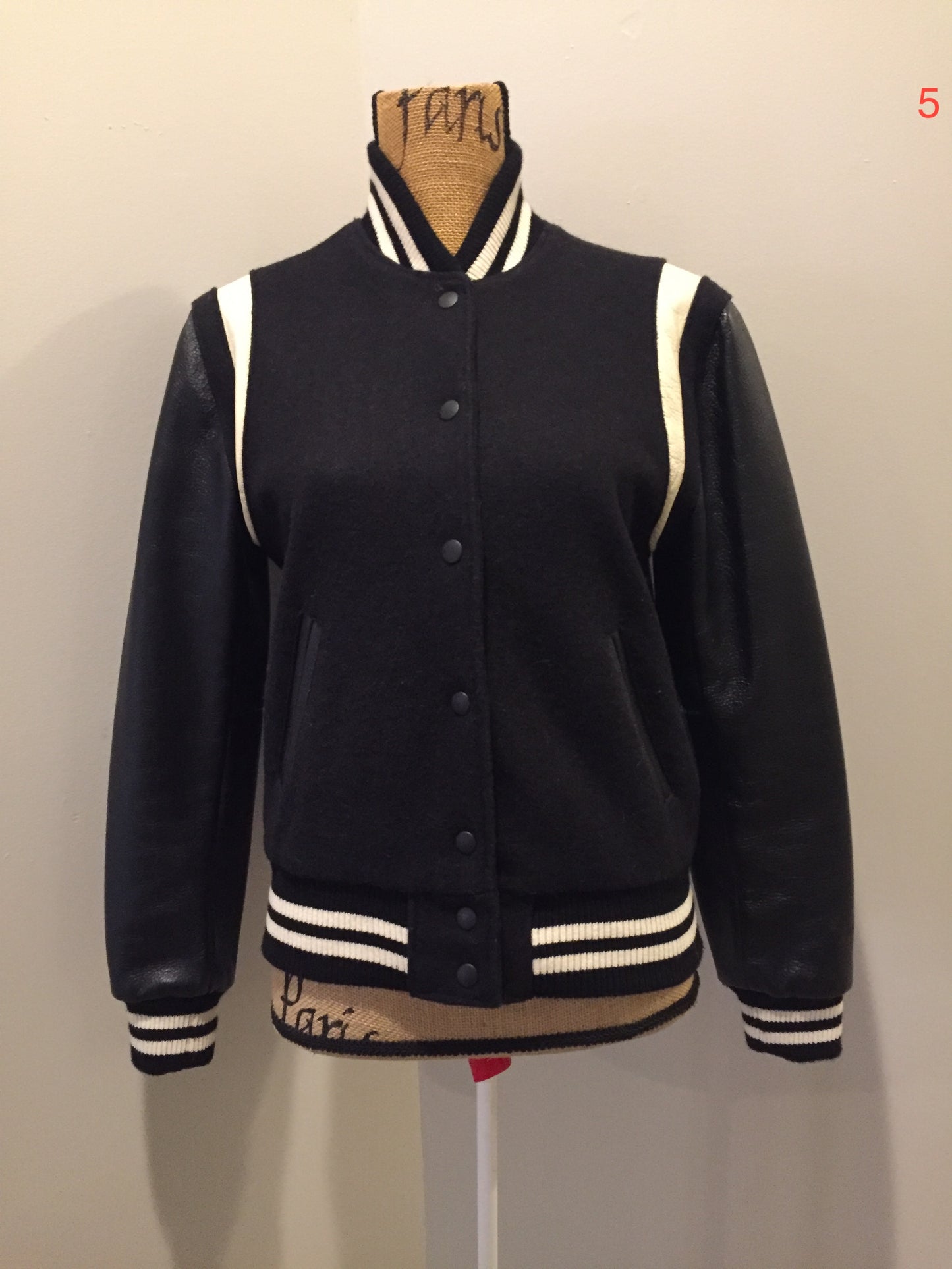 Kingspier Vintage - Roots wool and leather black varsity jacket with white stripe details, knit trim, snap closures, slash pockets and inside pocket. Made in Canada. Ladies size S.