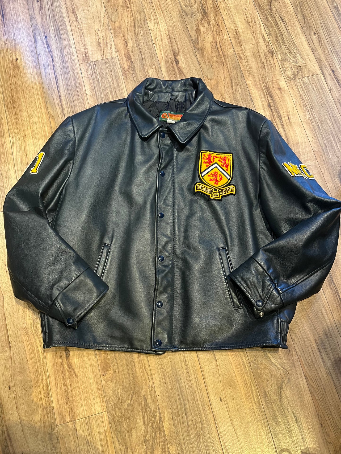 Vintage 70’s Waterloo Engineering Letterman’s leather varsity jacket by Export Leather Garments LTD.
Jacket features embroidered details on the chest, arms and back, two front pockets, zipper and snap closures and a quilted lining.
Made in Canada.
Size 52.