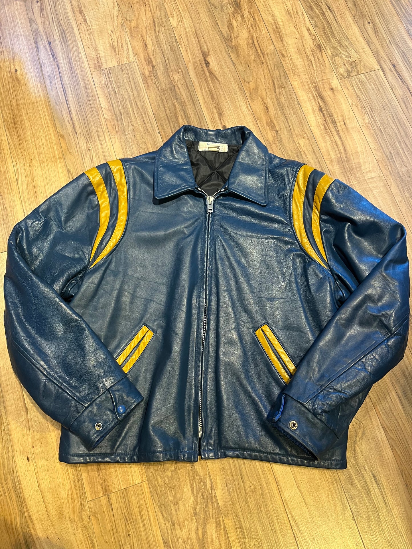 Bonwitt of Winnipeg blue and yellow leather varsity jacket.
Jacket features a zipper closure, two front pockets and a quilted lining.
Made in Canada.
Size XL