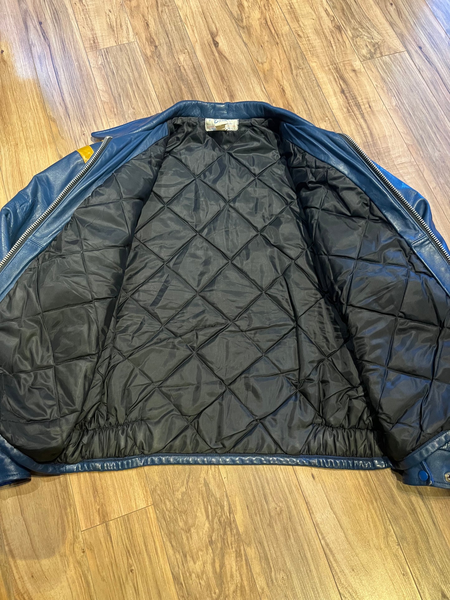 Bonwitt of Winnipeg blue and yellow leather varsity jacket.
Jacket features a zipper closure, two front pockets and a quilted lining.
Made in Canada.
Size XL