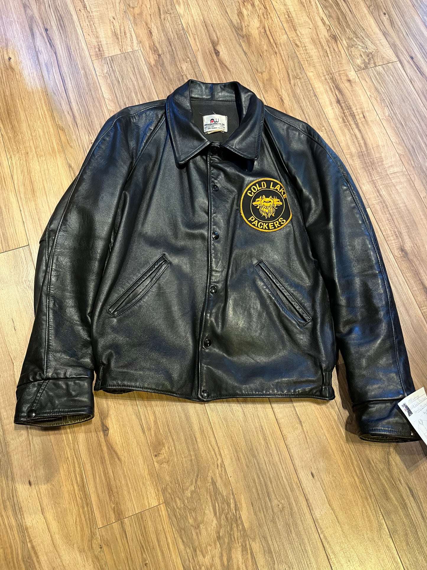 Vintage Cold Lake Packers Leather Varsity Jacket by Athletes Wear Co. LTD.
Jacket features embroidered detail on the chest, two front pockets and snap closures.
Made in Canada.
Chest 46”.