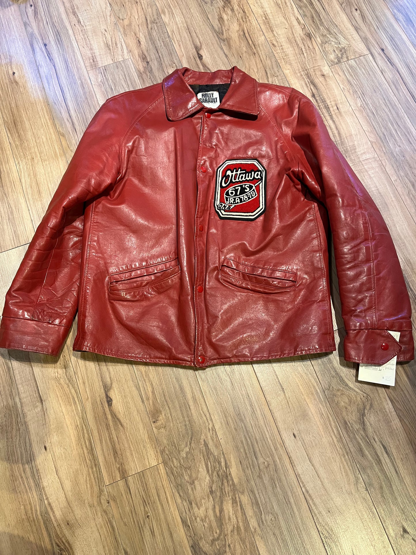 Vintage 70’s Ottawa 67s Red Leather Varsity Jacket by Rolly Sarault.
Jacket features embroidered details on the chest, snap closures, quilted lining and two front pockets.
Made in Canada.
Chest 46”.