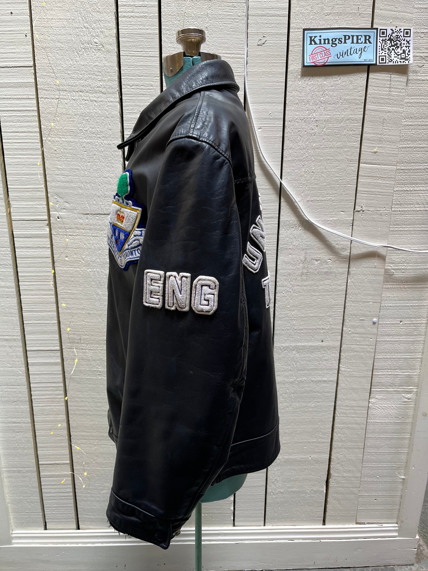 Vintage University of Toronto 1998 English Department Leather Varsity Jacket.
Jacket features embroidered details on the chest, arms and back, two front pockets, zipper and snap closures and a zip out quilted lining.
Size 46.