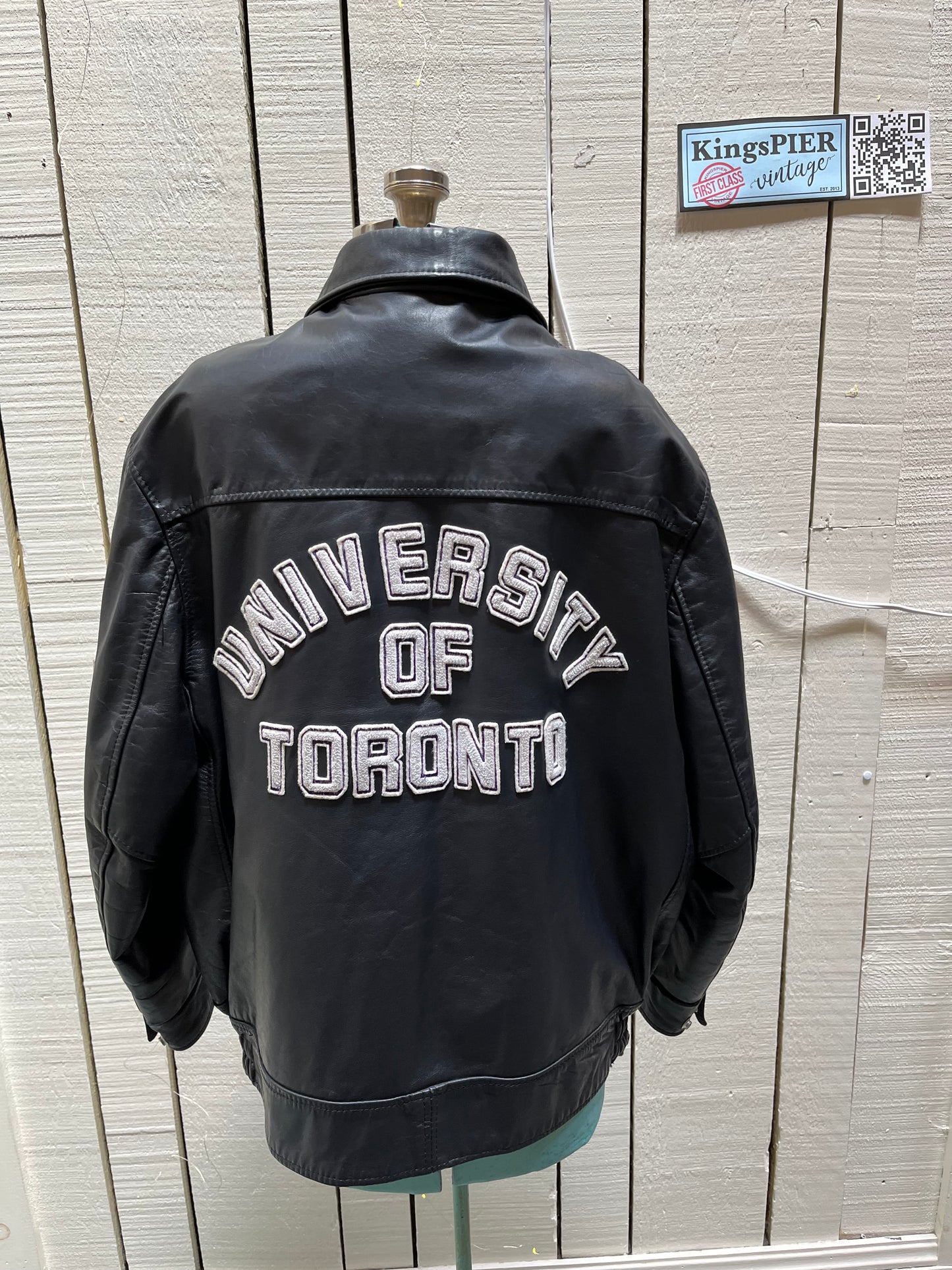 Vintage University of Toronto 1998 English Department Leather Varsity Jacket.
Jacket features embroidered details on the chest, arms and back, two front pockets, zipper and snap closures and a zip out quilted lining.
Size 46.