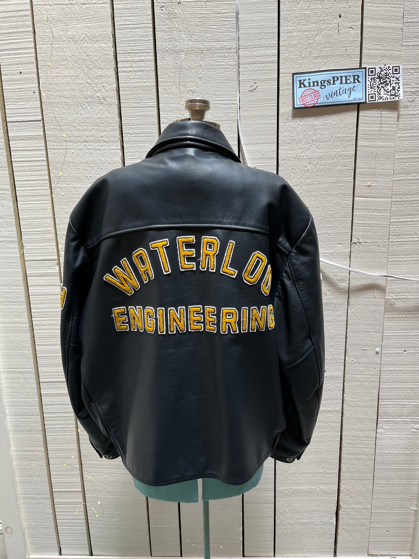 Vintage 70’s Waterloo Engineering Letterman’s leather varsity jacket by Export Leather Garments LTD.
Jacket features embroidered details on the chest, arms and back, two front pockets, zipper and snap closures and a quilted lining.
Made in Canada.
Size 52.