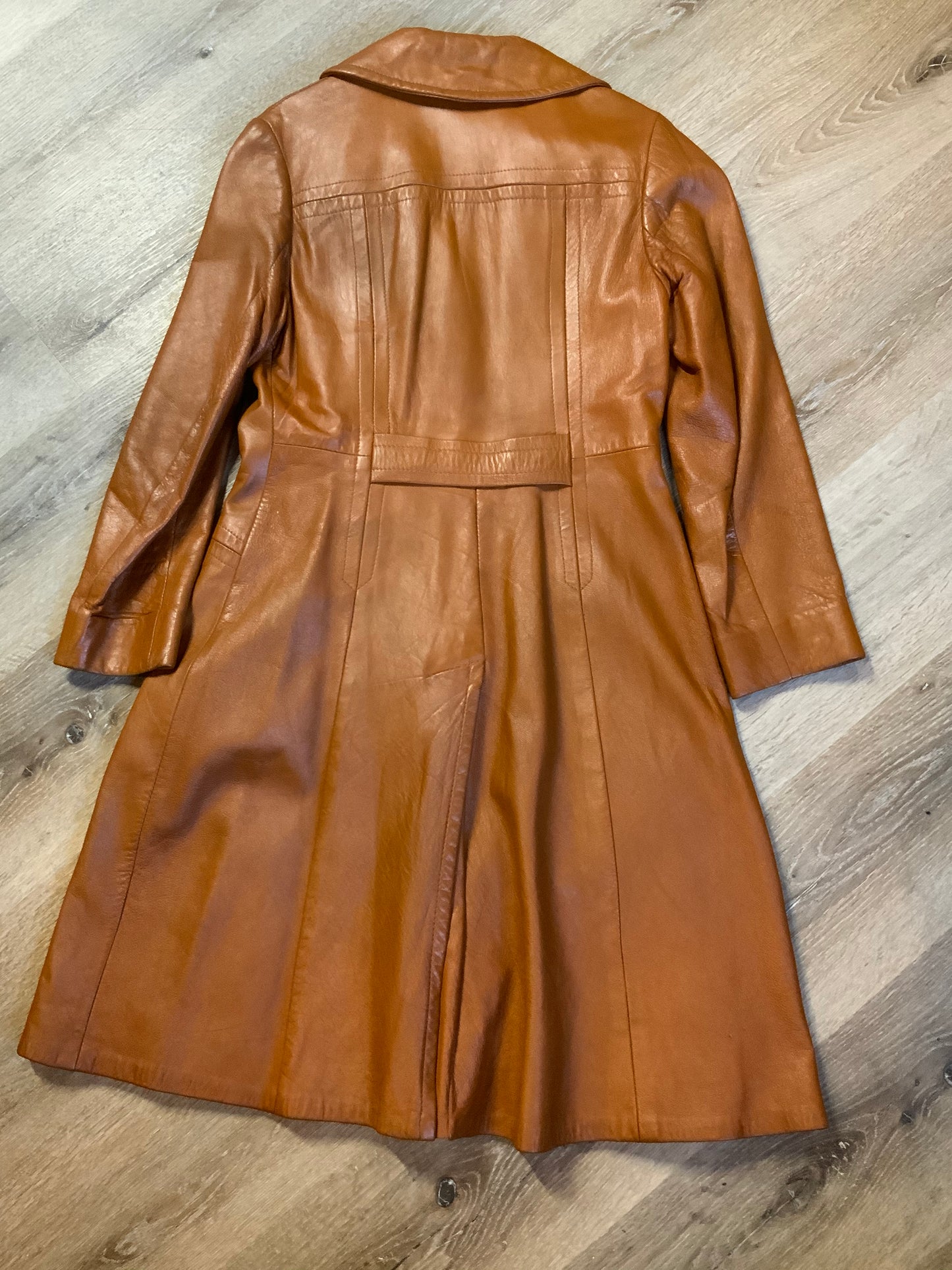 Kingspier Vintage - Form fitting 1970’s full length caramel brown leather coat with buttons down the front and a fun woven motif lining.
