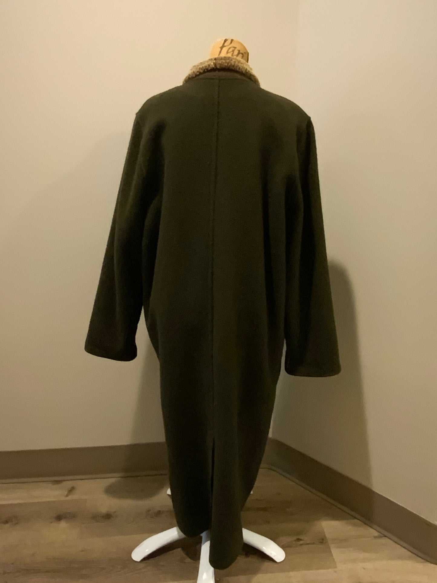 Kingspier Vintage - Epsilon full length moss green 100% wool coat with sheepskin panel running down the front. button closures with unique flower detail, front pockets and a zip out inside lining. Made in Canada. Fits a size large.