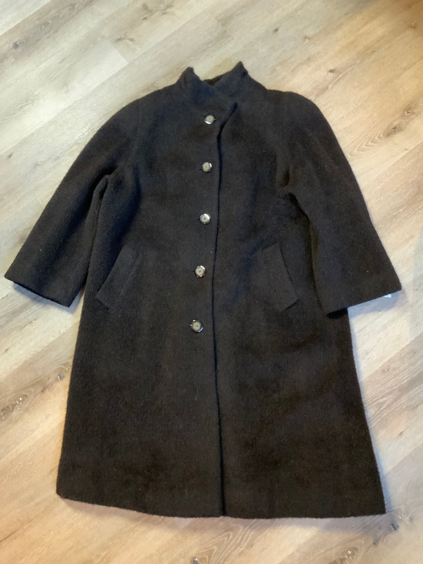 Kingspier Vintage - Regency 1970’s dark brown alpaca wool full length coat with front pockets and buttons, shoulder pads and pleating detail in the back. Features an ILGWU, Made in the USA label on inner lining. Fits a Size 8.