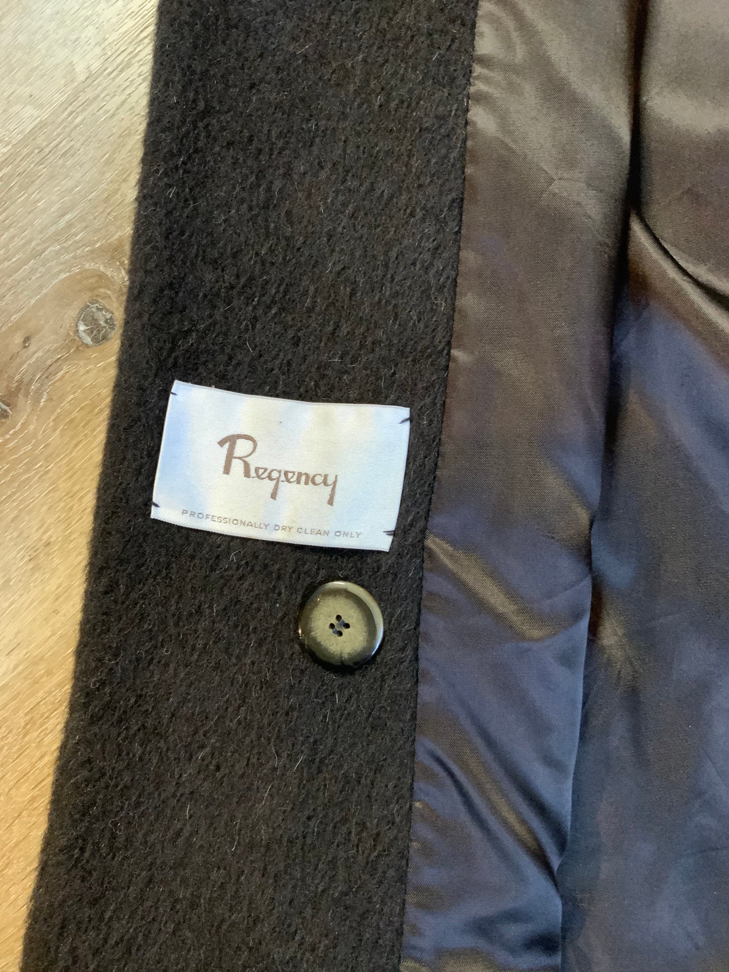 Kingspier Vintage - Regency 1970’s dark brown alpaca wool full length coat with front pockets and buttons, shoulder pads and pleating detail in the back. Features an ILGWU, Made in the USA label on inner lining. Fits a Size 8.