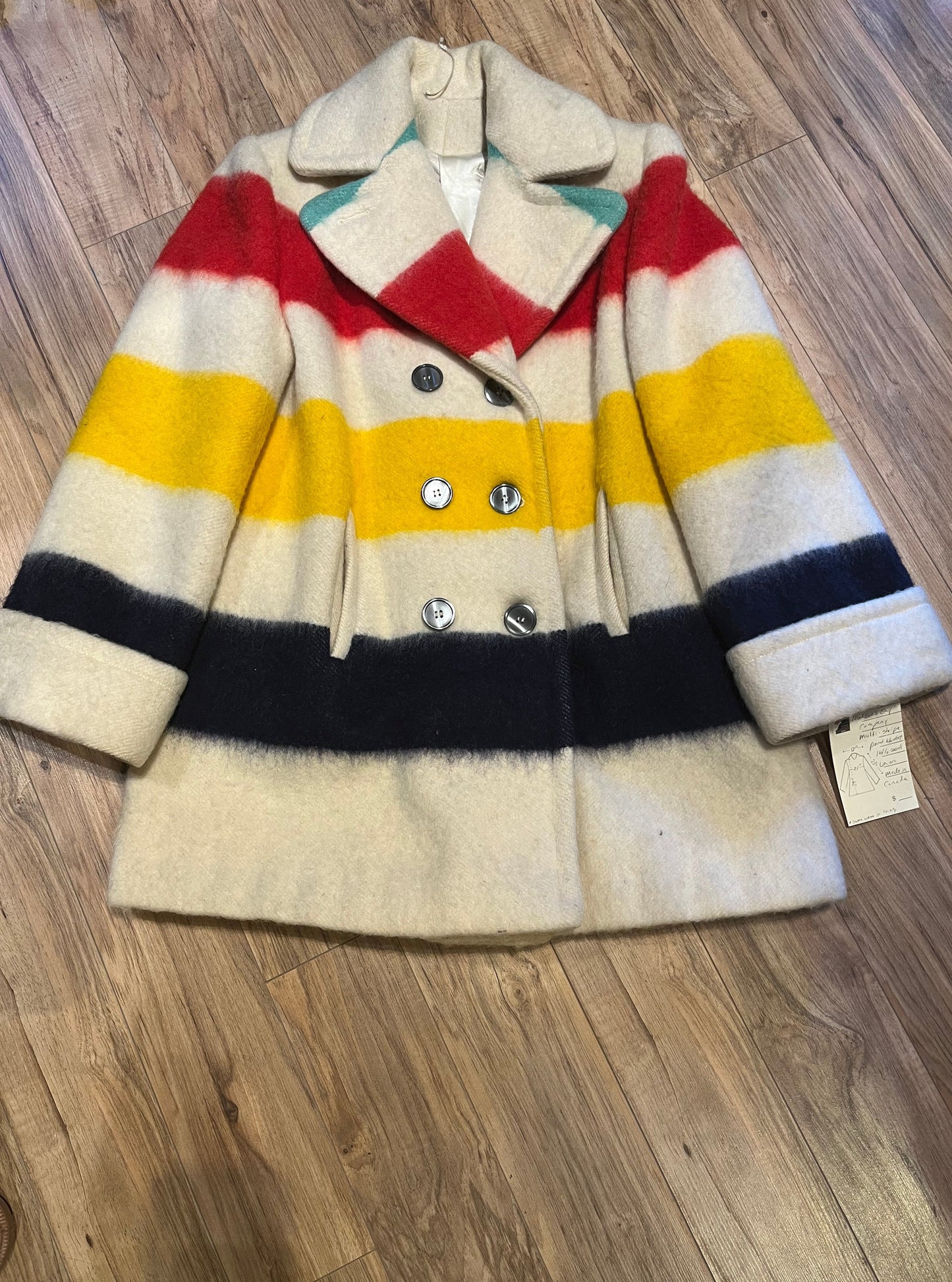 Genuine Hudson’s Bay Company 100% wool point blanket coat in the iconic multi-stripe colours. The coat is double breasted with pockets and a satin lining.
Union made in Canada.
Chest measures 42”.