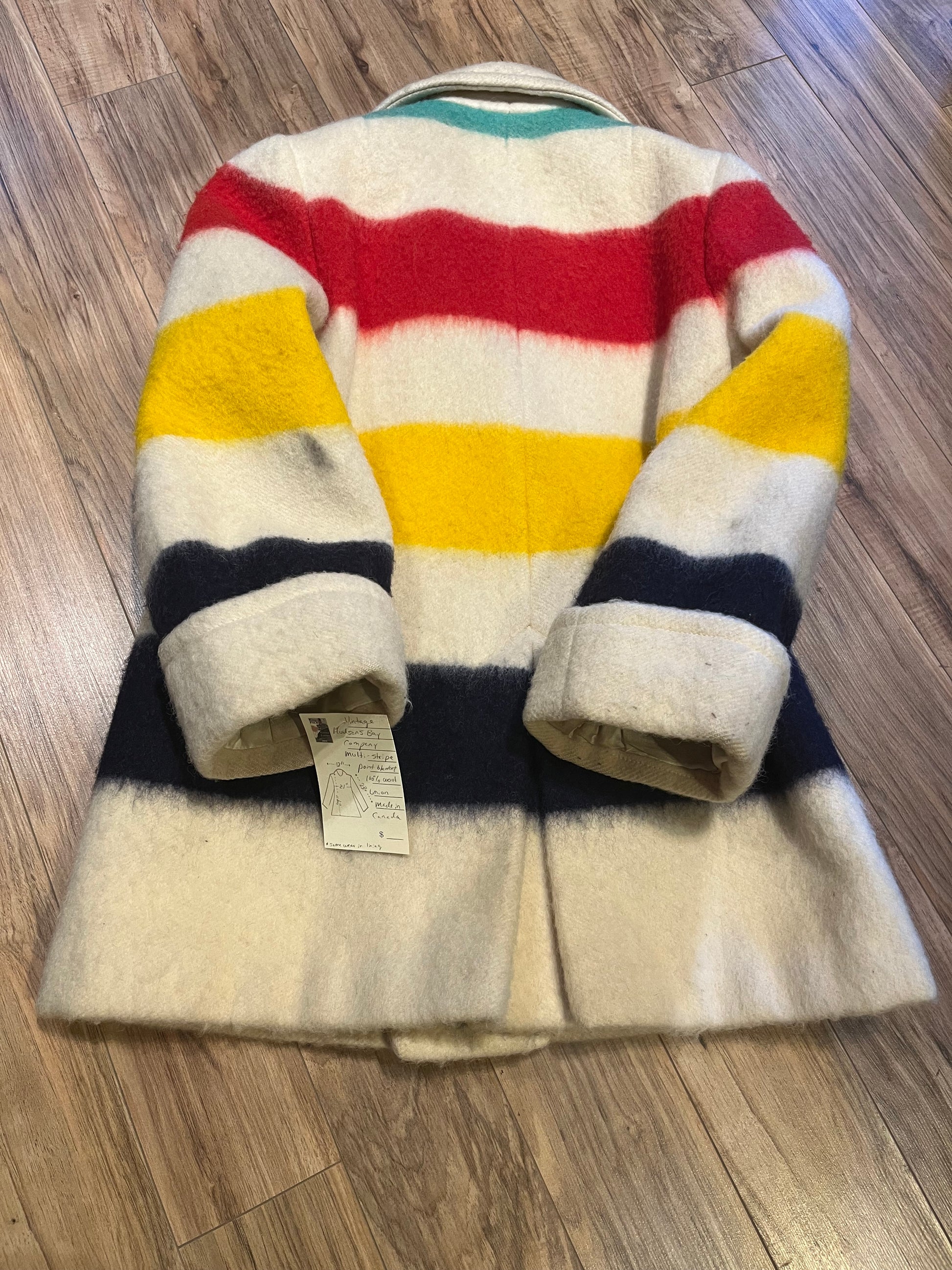 Genuine Hudson’s Bay Company 100% wool point blanket coat in the iconic multi-stripe colours. The coat is double breasted with pockets and a satin lining.
Union made in Canada. 
Chest measures 42”.