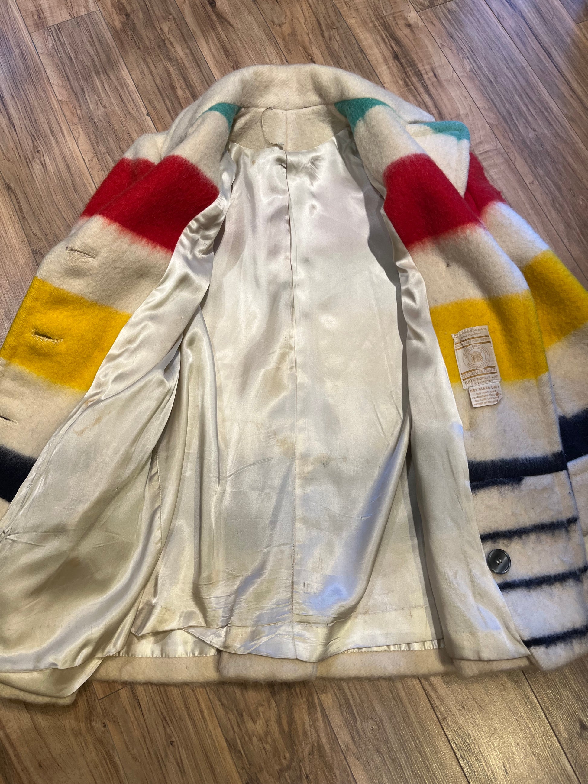 Genuine Hudson’s Bay Company 100% wool point blanket coat in the iconic multi-stripe colours. The coat is double breasted with pockets and a satin lining.
Union made in Canada. 
Chest measures 42”.