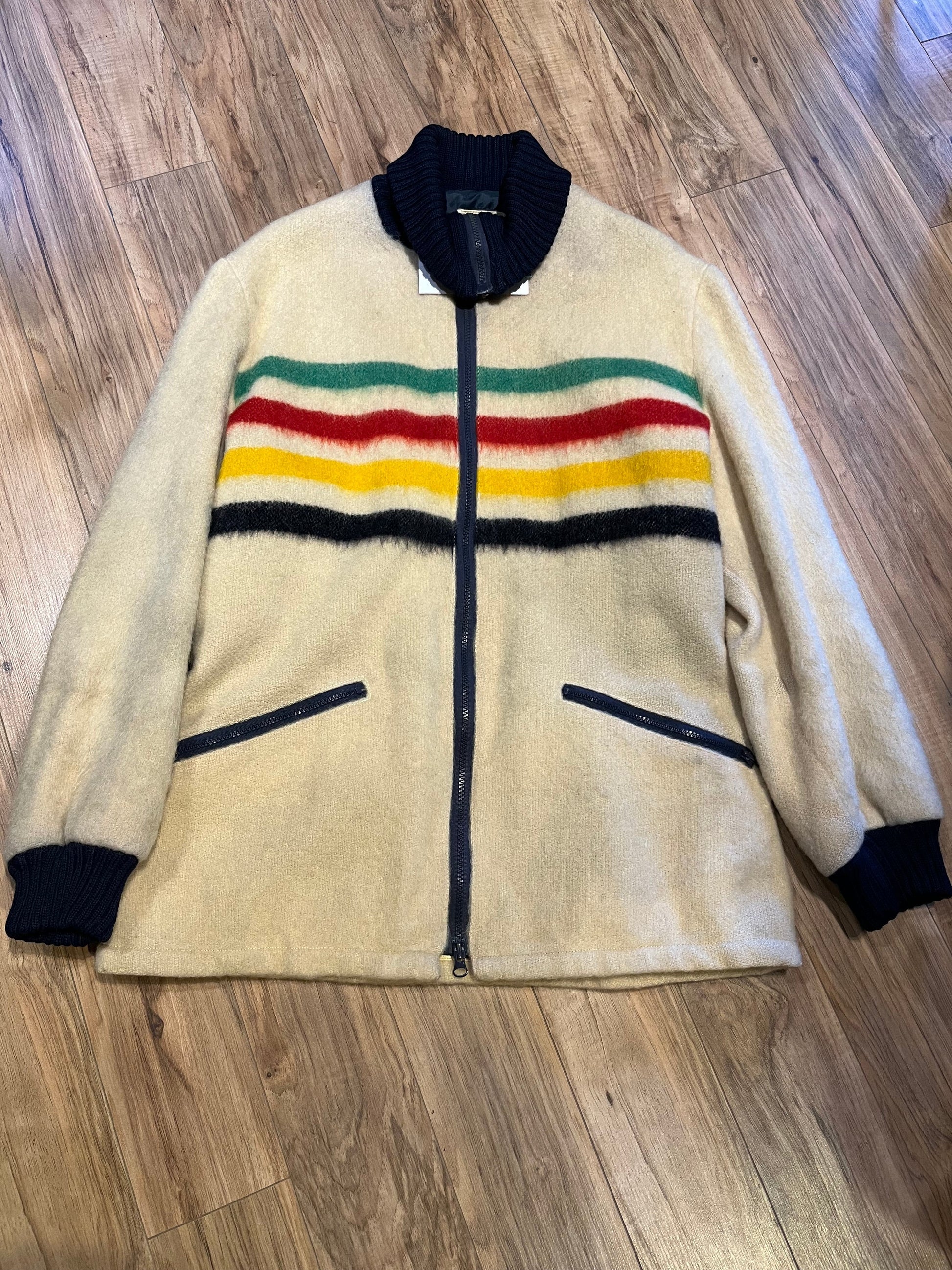 Genuine Hudson’s Bay Company 100% wool point blanket zip cardigan in the iconic multi-stripe colours with two zip front pockets.
Union made in Canada. 
Size medium.