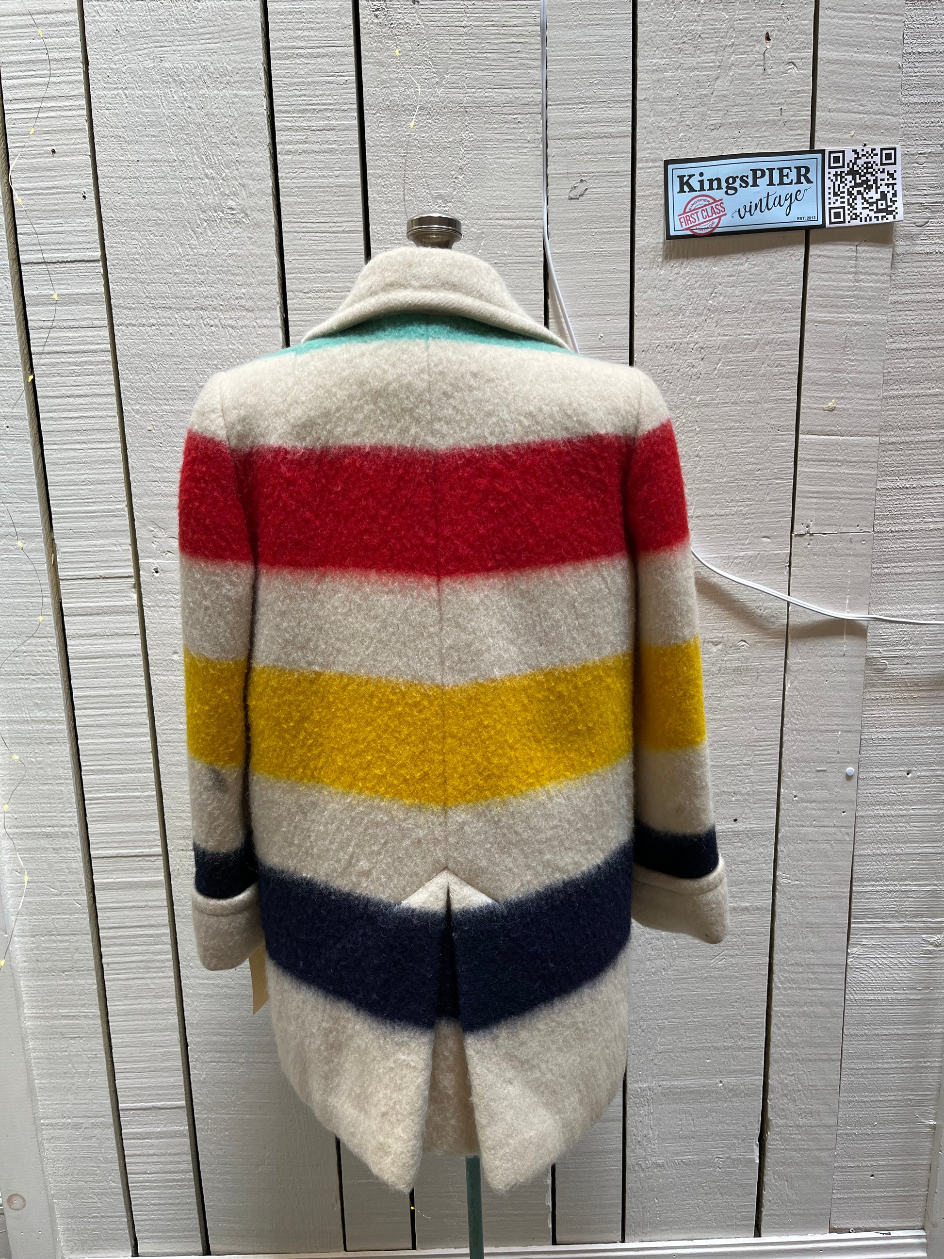 Genuine Hudson’s Bay Company 100% wool point blanket coat in the iconic multi-stripe colours. The coat is double breasted with pockets and a satin lining.
Union made in Canada. 
Chest measures 42”.