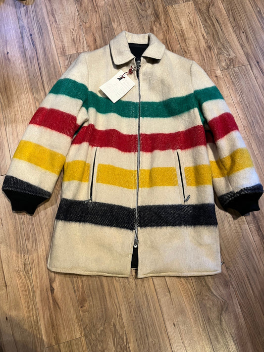 Genuine Hudson’s Bay Company 100% wool point blanket coat in the iconic multi-stripe colours. The coat features a reversible black nylon side with a hood zipped into the collar, zip pockets on both sides and knit cuffs.
Made in Canada. 
Chest measures 42”.