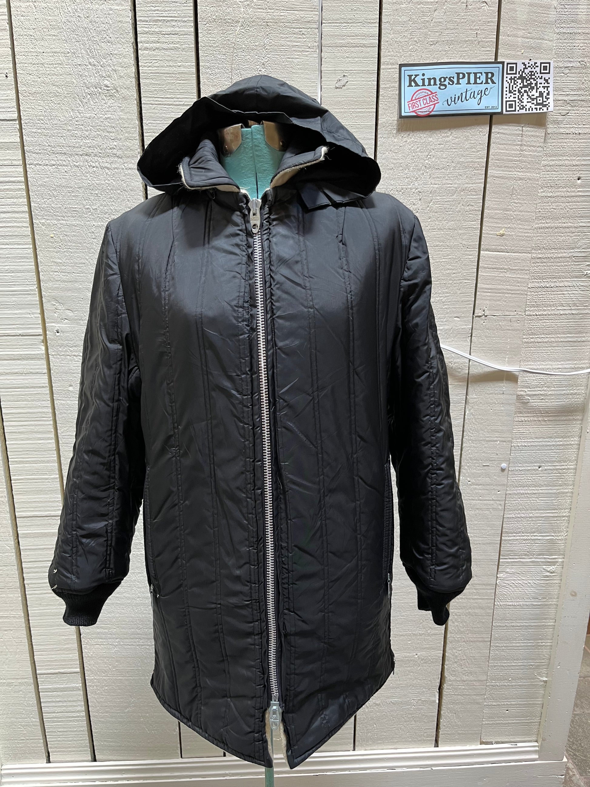Genuine Hudson’s Bay Company 100% wool point blanket coat in the iconic multi-stripe colours. The coat features a reversible black nylon side with a hood zipped into the collar, zip pockets on both sides and knit cuffs.
Made in Canada. 
Chest measures 42”.