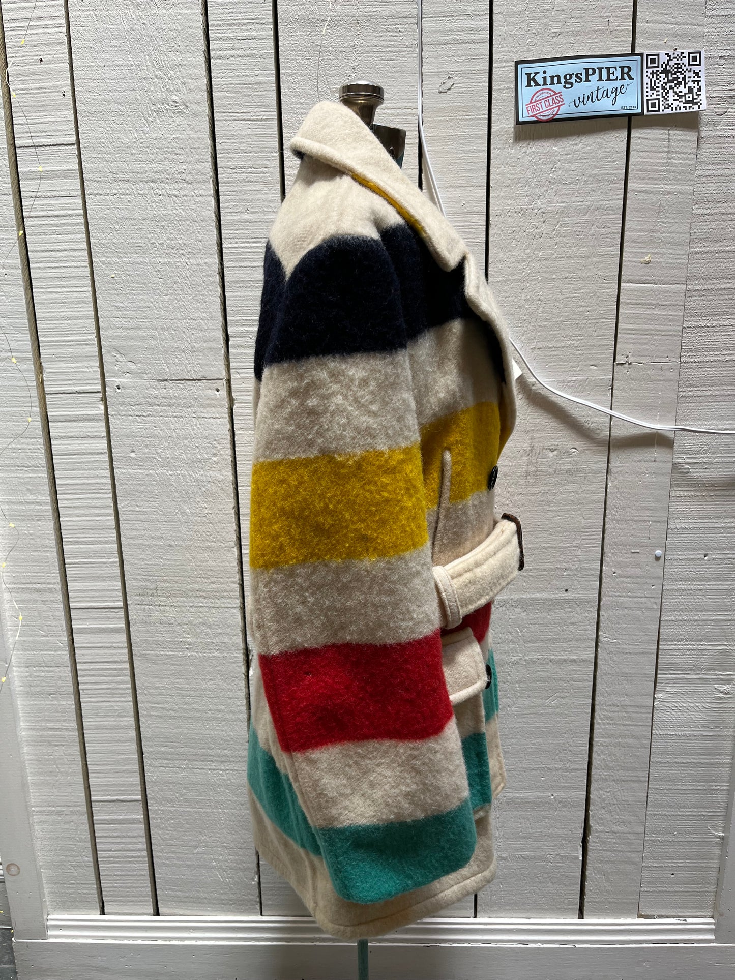 Genuine 1960’s Hudson’s Bay Company 100% wool point blanket coat in the iconic multi-stripe colours. The coat features flap pockets and hand warmer pockets, double breasted button closures and belt.
Made in Canada.
Chest 40”