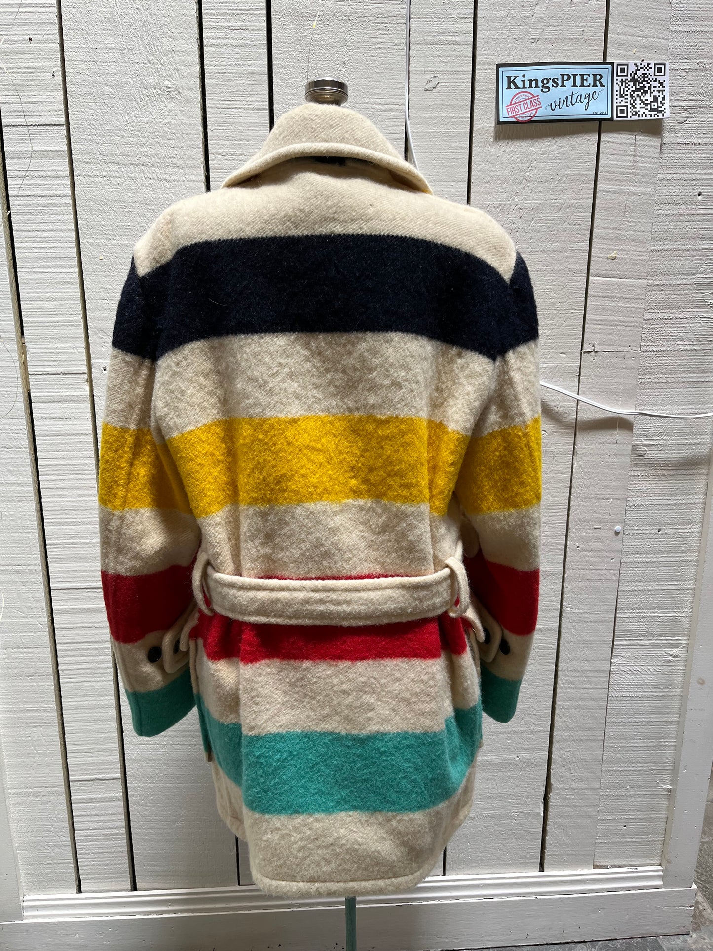 Genuine 1960’s Hudson’s Bay Company 100% wool point blanket coat in the iconic multi-stripe colours. The coat features flap pockets and hand warmer pockets, double breasted button closures and belt.
Made in Canada.
Chest 40”