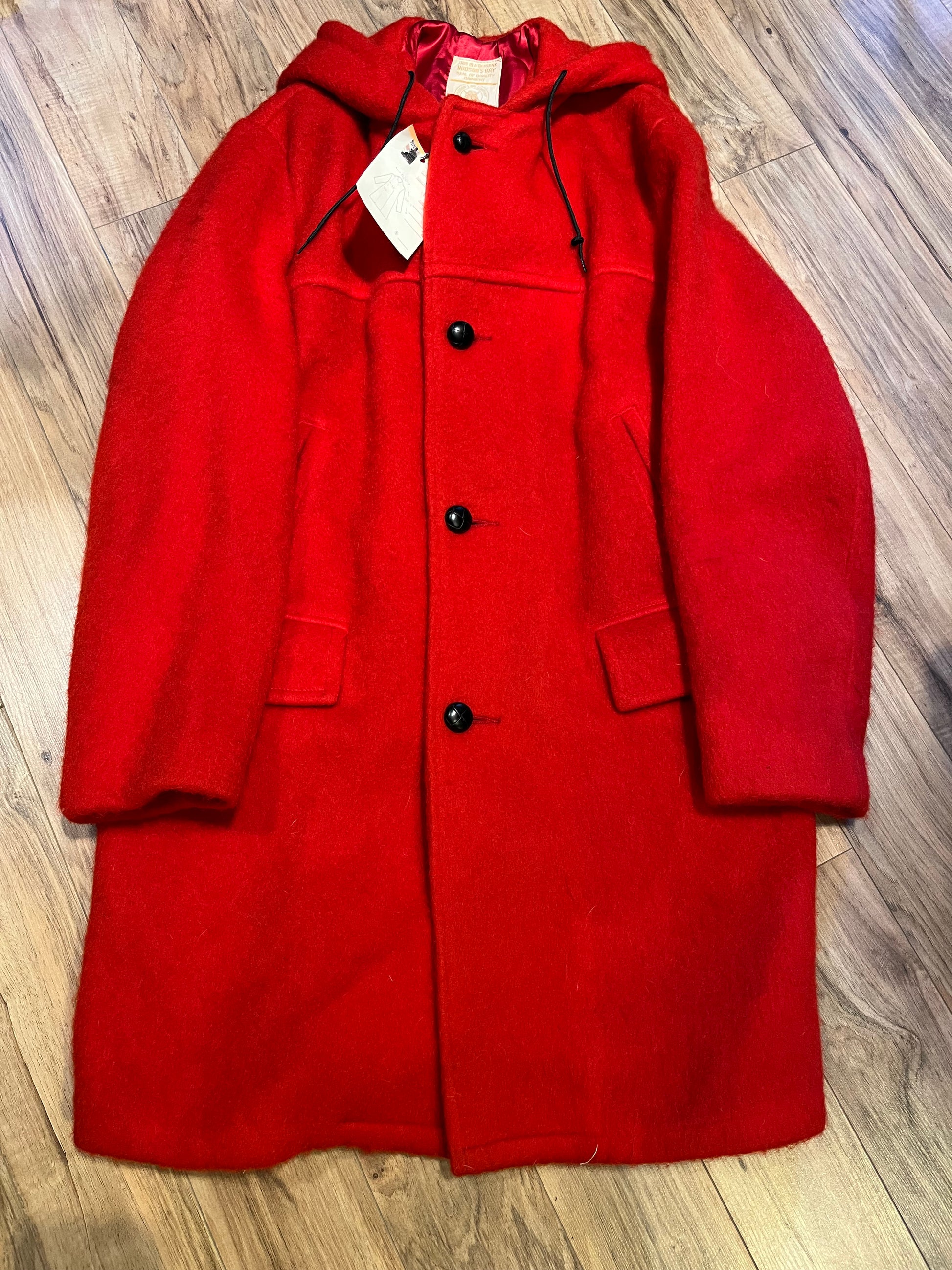 Genuine Hudson’s Bay Company 100% wool point blanket coat in bright red. The coat features flap pockets and hand warmer pockets, leather buttons, zip closure and a hood. 
Made in Canada. 
Size medium.