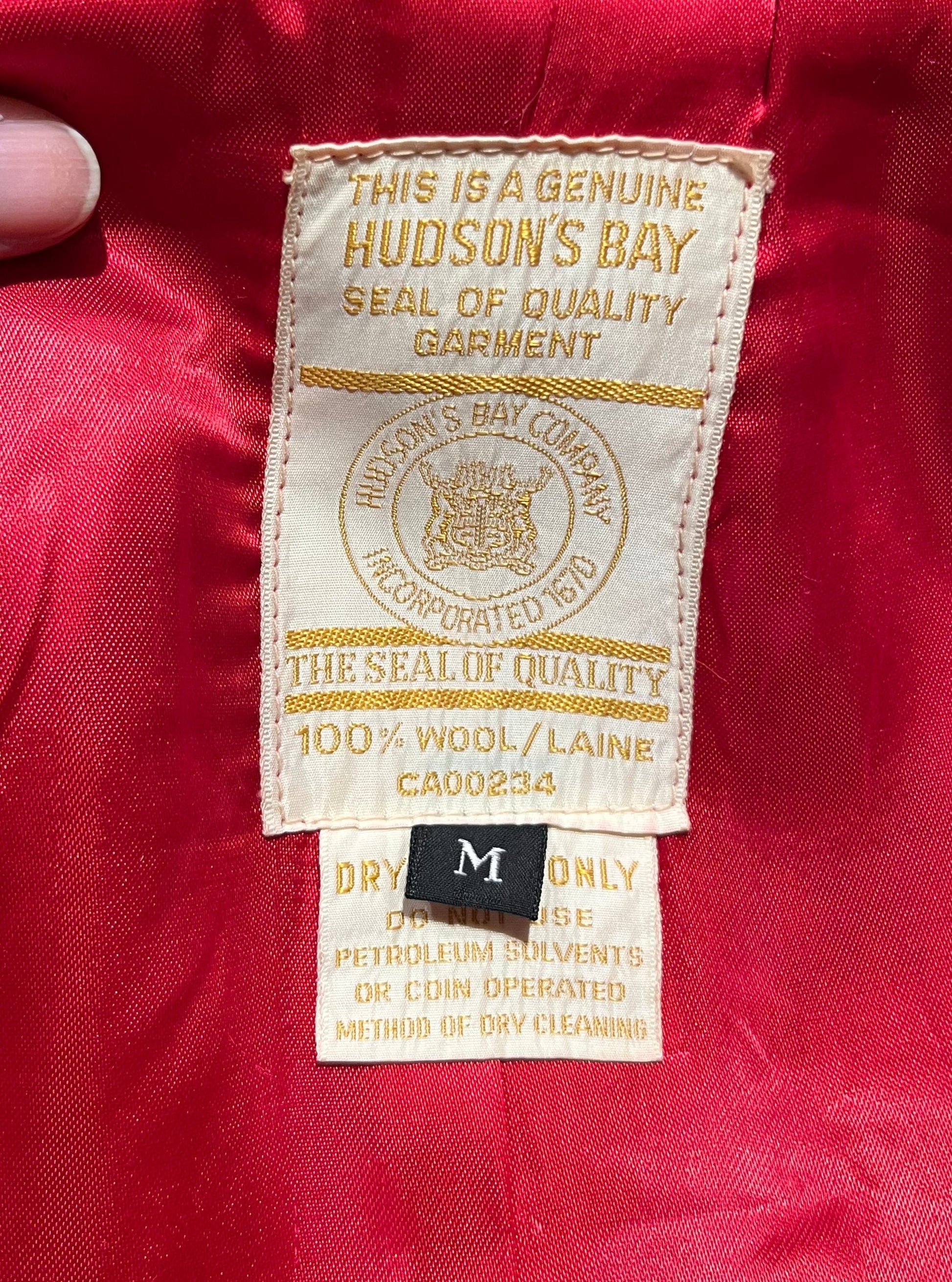 Genuine Hudson’s Bay Company 100% wool point blanket coat in bright red. The coat features flap pockets and hand warmer pockets, leather buttons, zip closure and a hood. 
Made in Canada. 
Size medium.