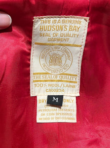 Genuine Hudson’s Bay Company 100% wool point blanket coat in bright red. The coat features flap pockets and hand warmer pockets, leather buttons, zip closure and a hood. 

Made in Canada. 
Size medium.