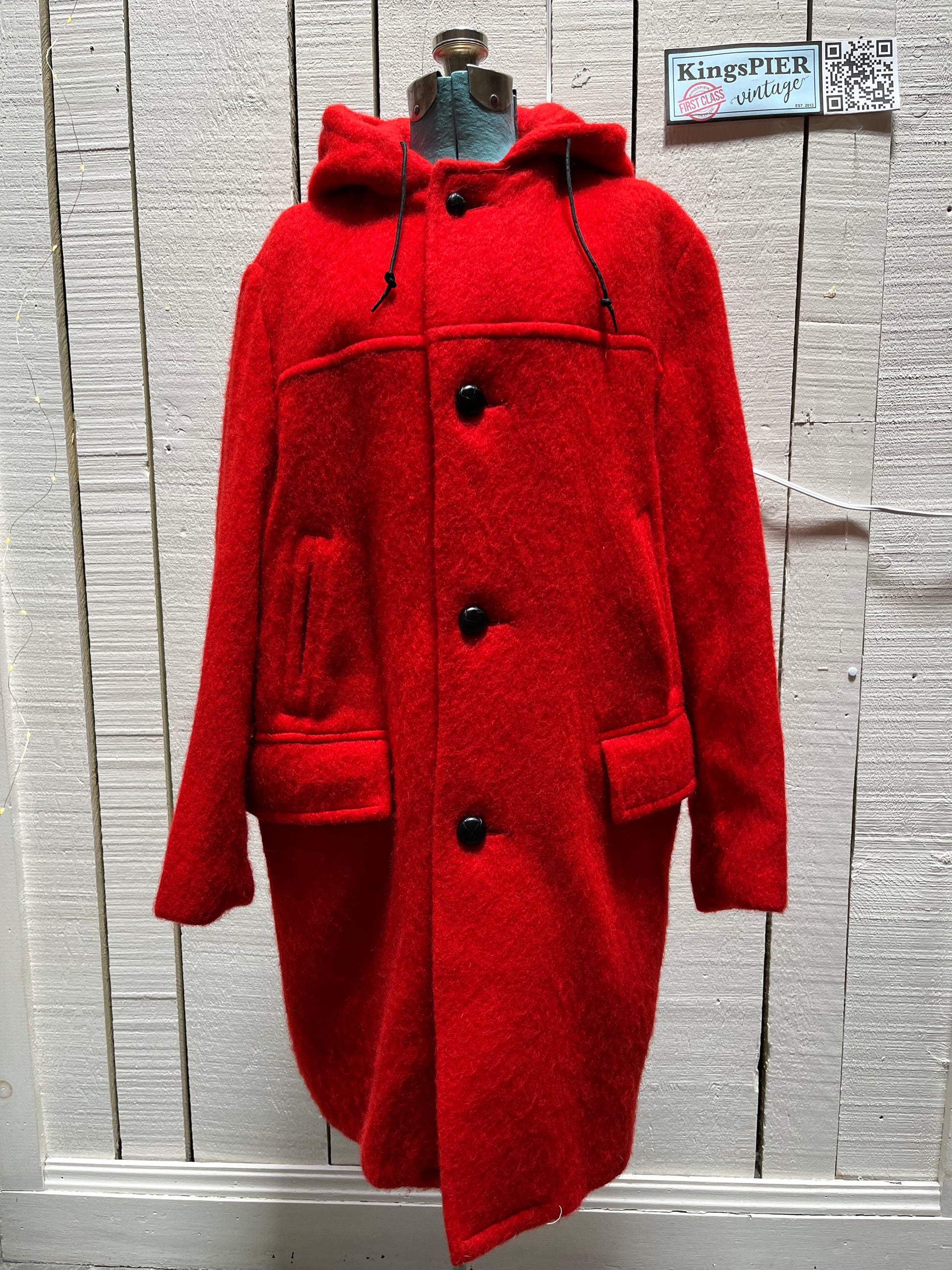 Genuine Hudson’s Bay Company 100% wool point blanket coat in bright red. The coat features flap pockets and hand warmer pockets, leather buttons, zip closure and a hood. 
Made in Canada. 
Size medium.