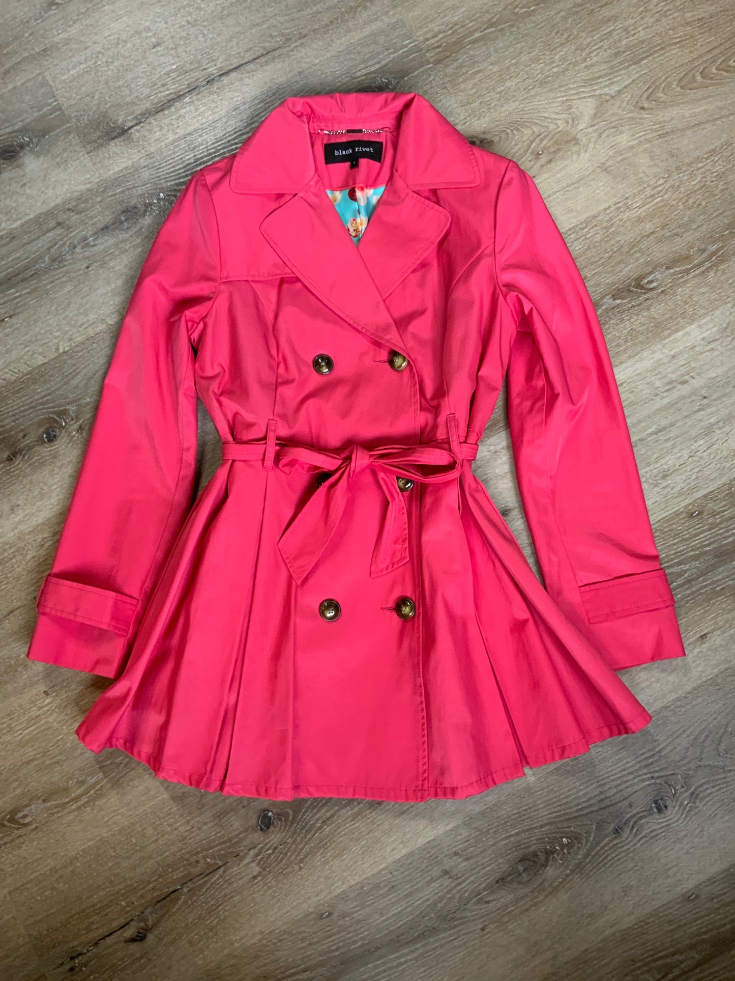 Kingspier Vintage - Black Rivet bright pink double breasted trench coat with belt, welt pockets, pleated skirt and vibrant flower motif lining. Size small.