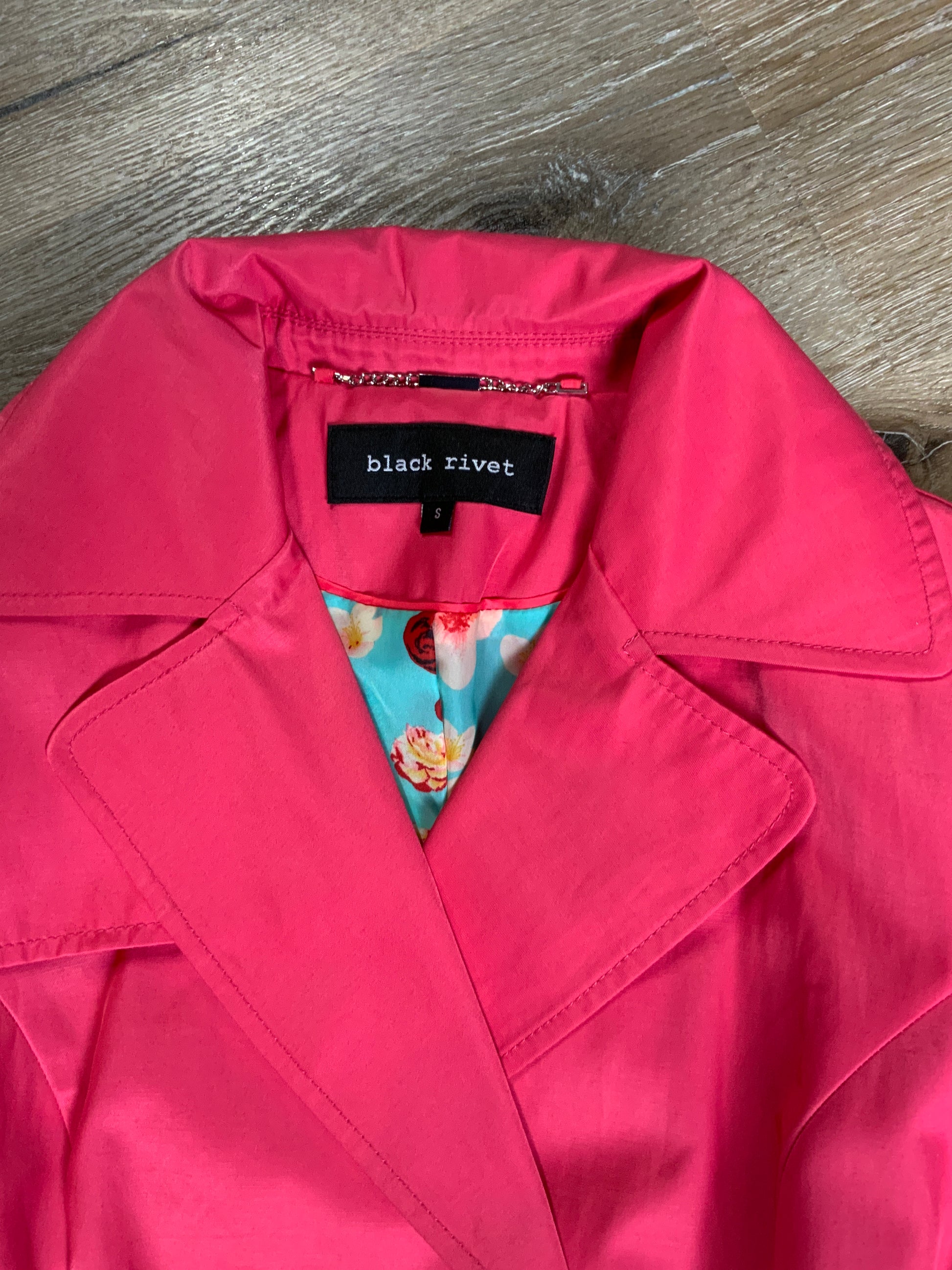 Kingspier Vintage - Black Rivet bright pink double breasted trench coat with belt, welt pockets, pleated skirt and vibrant flower motif lining. Size small.