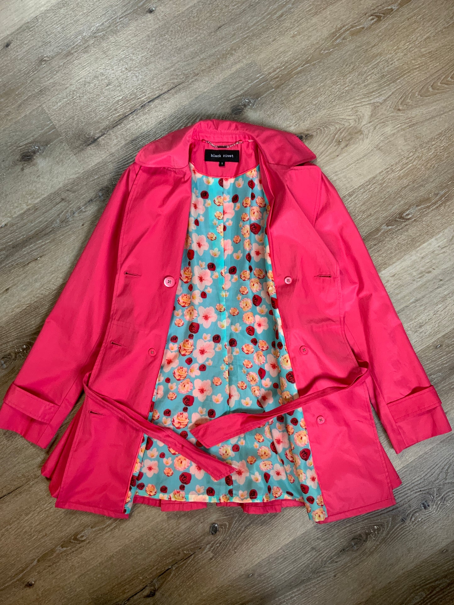 Kingspier Vintage - Black Rivet bright pink double breasted trench coat with belt, welt pockets, pleated skirt and vibrant flower motif lining. Size small.