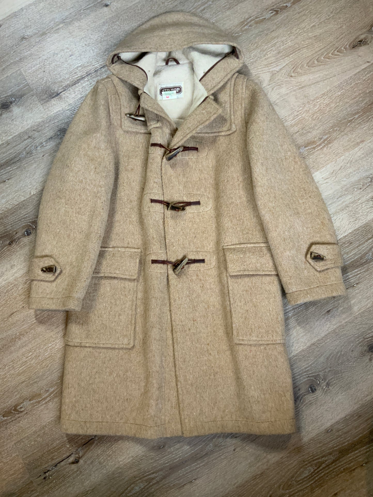 Kingspier Vintage - Tip Top beige textured wool duffle coat with hood, zipper, wooden toggles and flap pockets. Size 38.