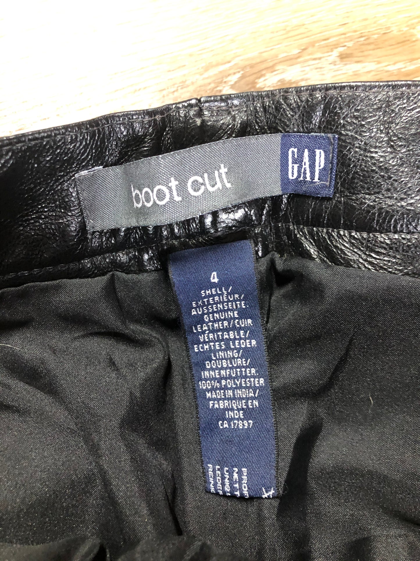 Vintage Gap black straight leg leather pants with zipper fly, and front and back pockets, partially lined. Size 4 (30x32).