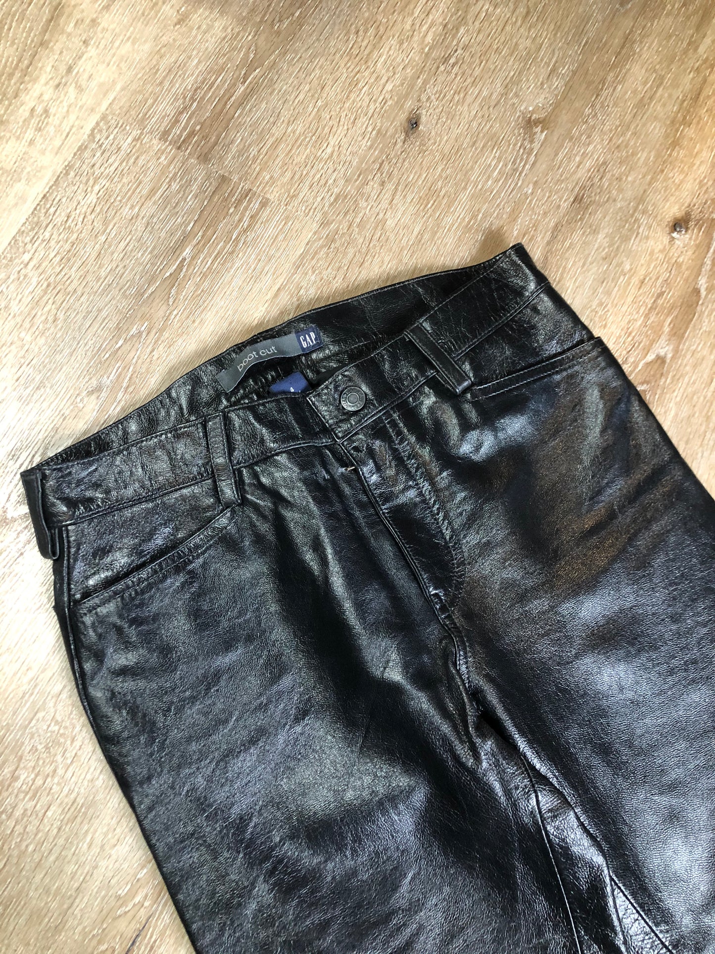 Vintage Gap black straight leg leather pants with zipper fly, and front and back pockets, partially lined. Size 4 (30x32).