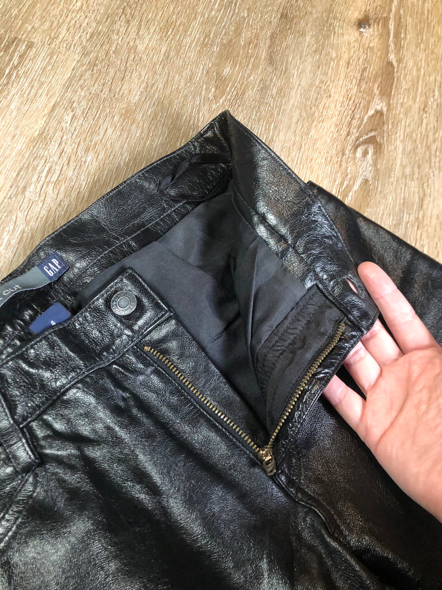 Vintage Gap black straight leg leather pants with zipper fly, and front and back pockets, partially lined. Size 4 (30x32).