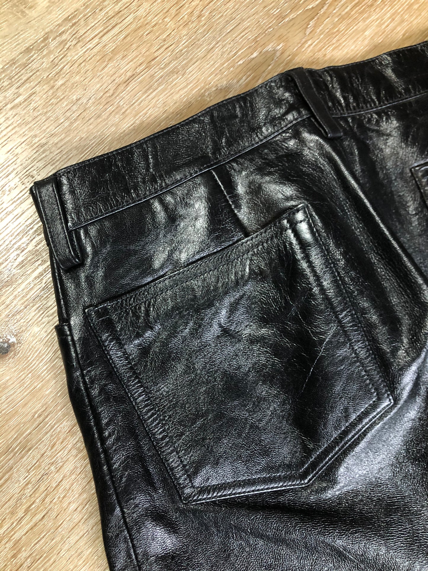 Vintage Gap black straight leg leather pants with zipper fly, and front and back pockets, partially lined. Size 4 (30x32).