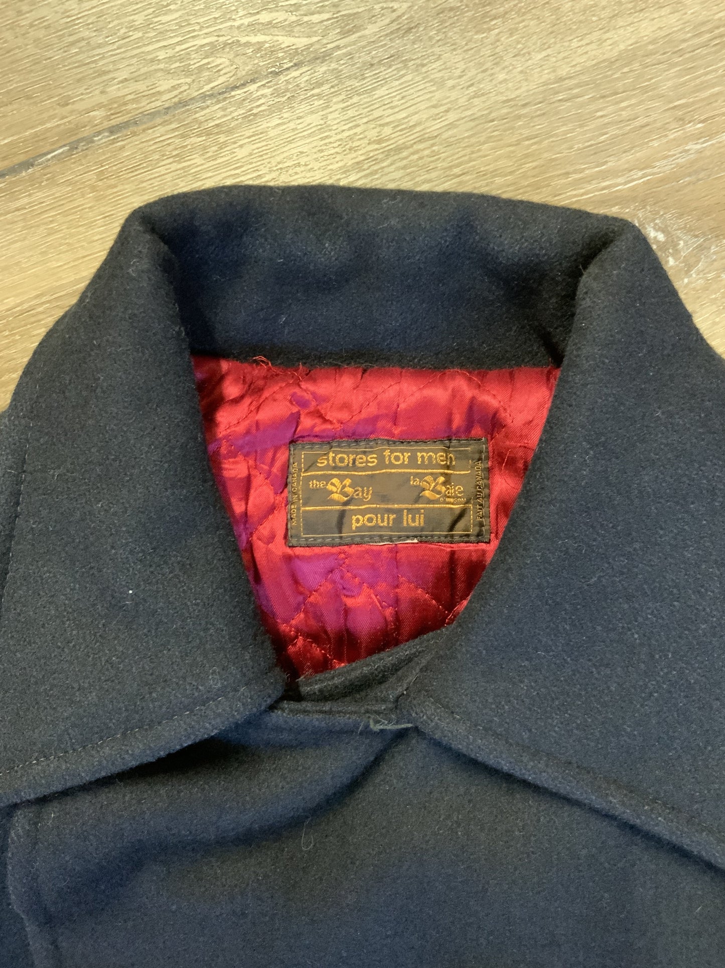 Kingspier Vintage - The Bay navy blue wool blend peacoat with front welt pockets and flap pockets plus a raspberry colour quilted lining. Made in Canada. Size 40.
