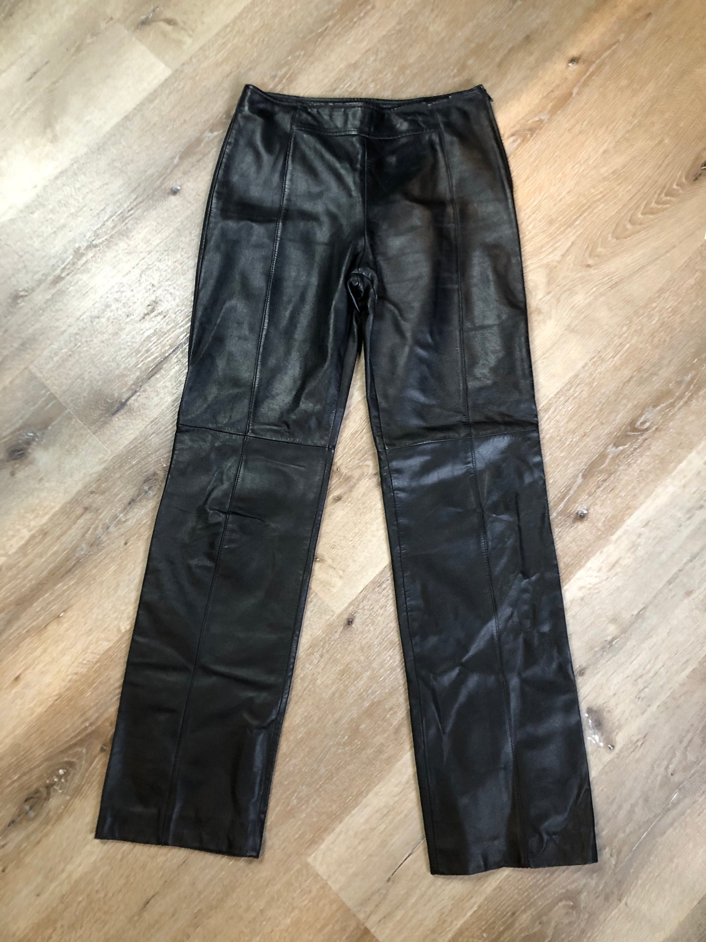 Danier black leather straight leg pants with side zip closure, partially lined. Size 4 Canadian (28x31).
