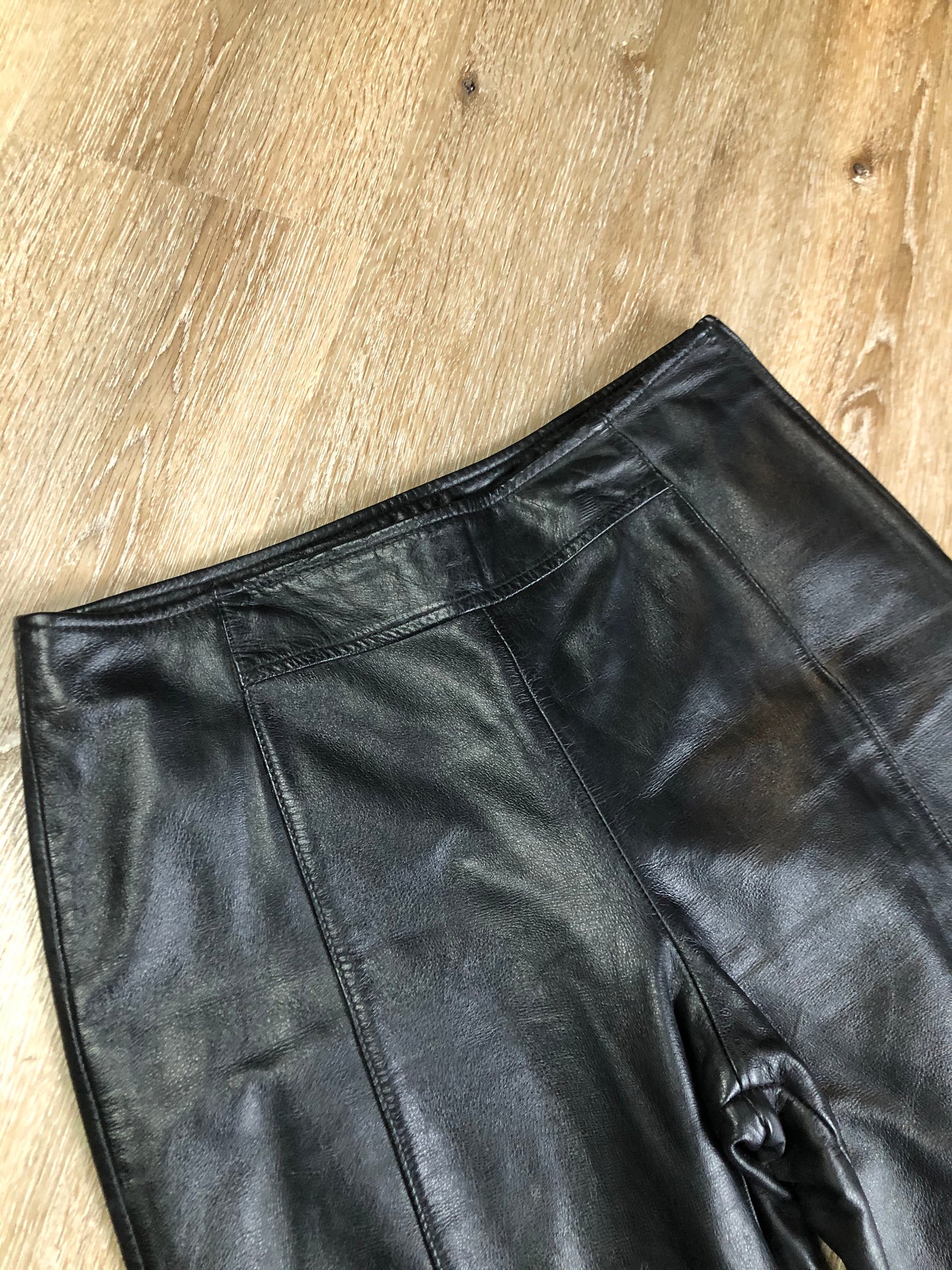 Danier black leather straight leg pants with side zip closure, partially lined. Size 4 Canadian (28x31).