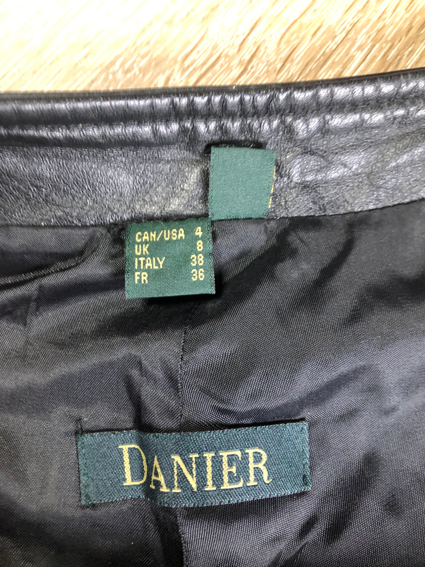 Danier black leather straight leg pants with side zip closure, partially lined. Size 4 Canadian (28x31).