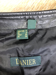 Danier black leather straight leg pants with side zip closure, partially lined. Size 4 Canadian (28x31).
