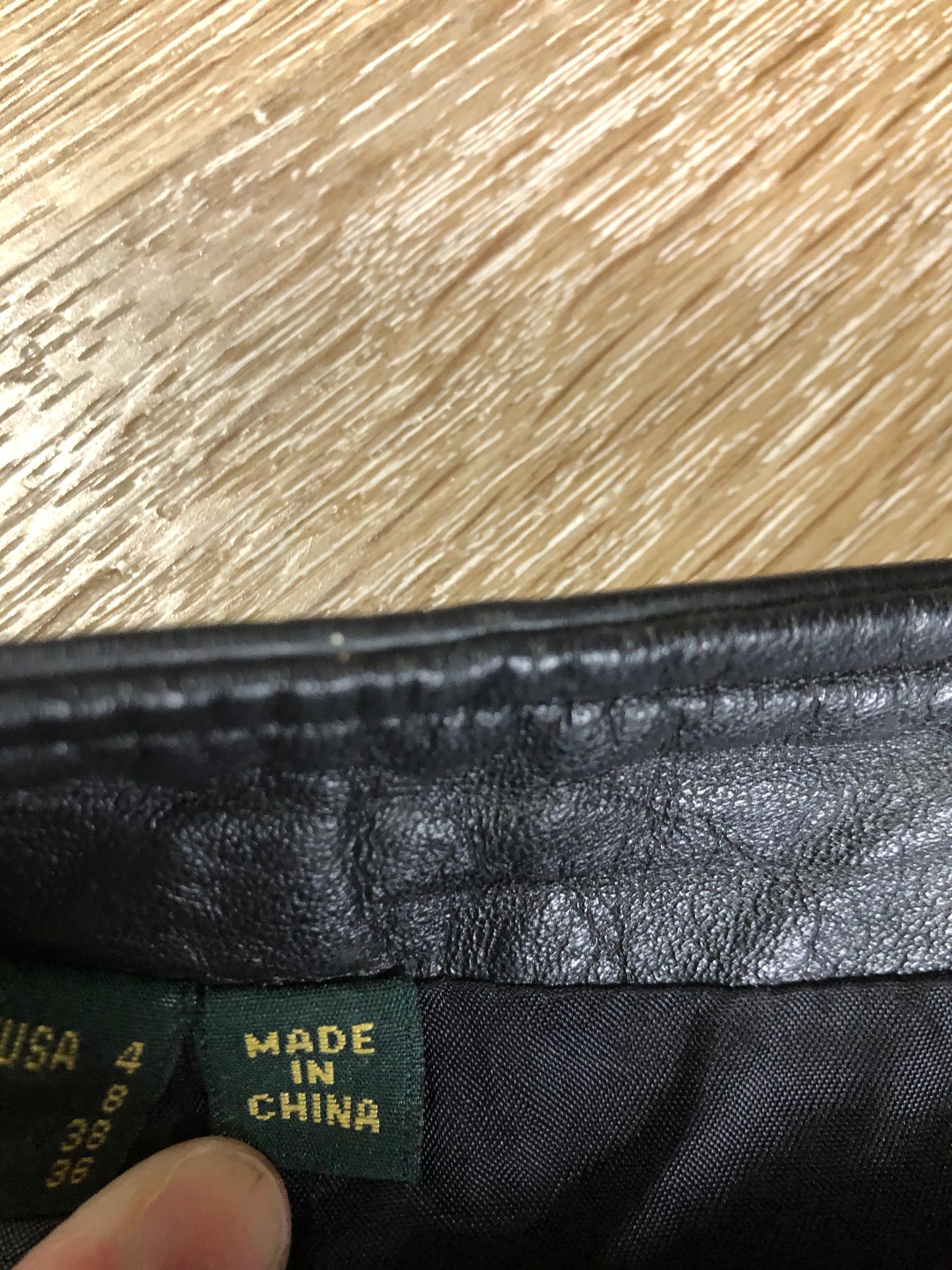 Danier black leather straight leg pants with side zip closure, partially lined. Size 4 Canadian (28x31).