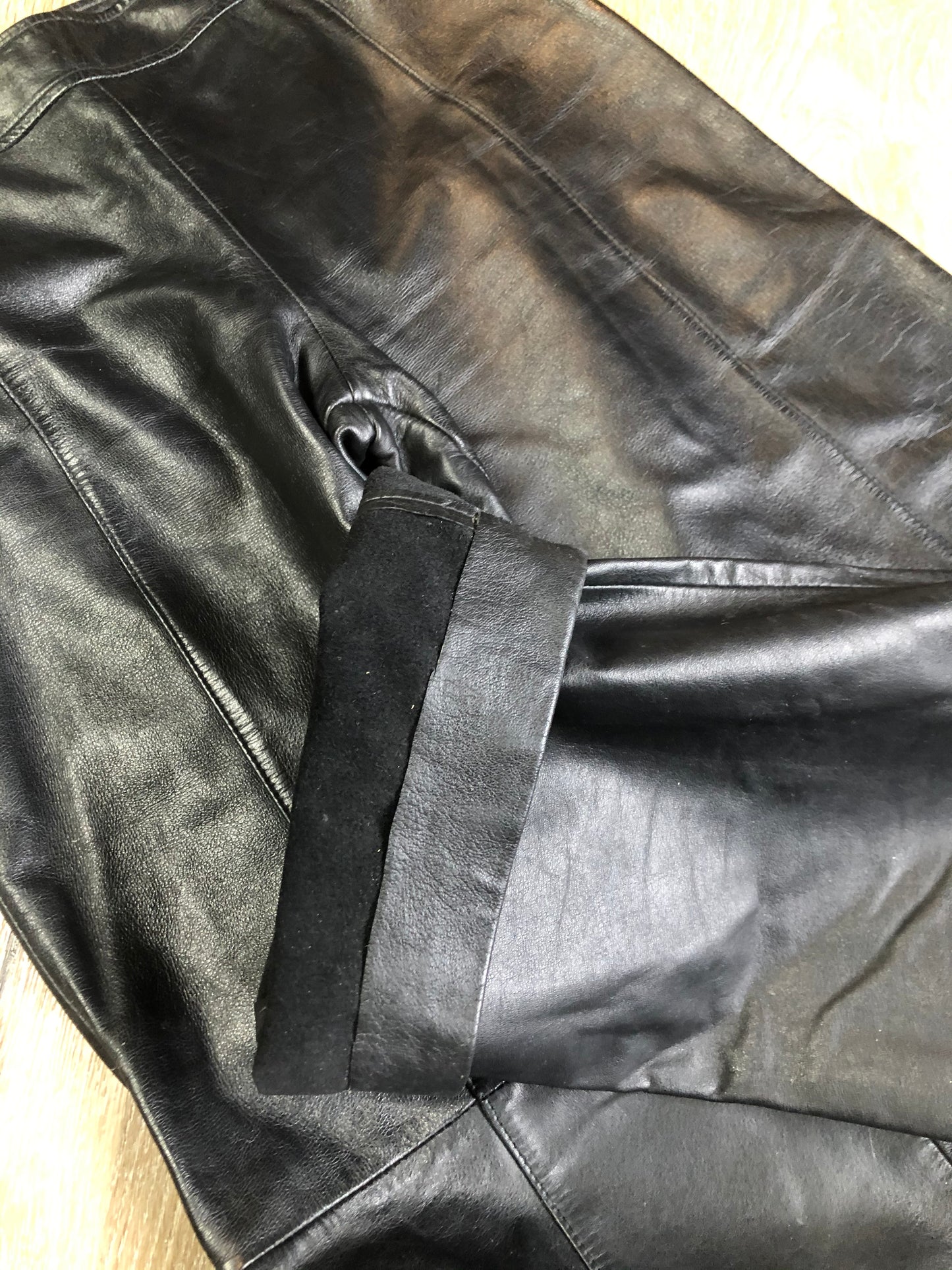 Danier black leather straight leg pants with side zip closure, partially lined. Size 4 Canadian (28x31).